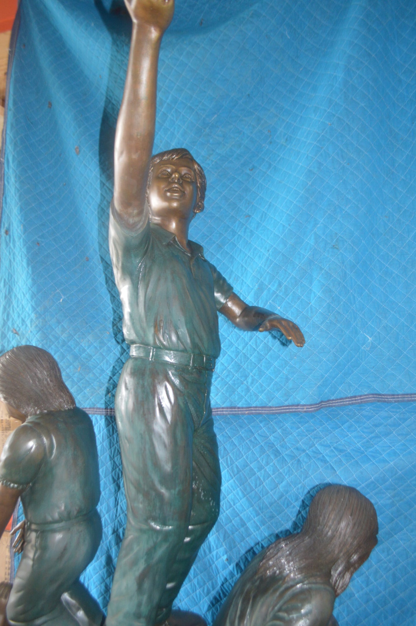 Four Kids Playing on a Rock Bronze Statue - Size: 49"L x 26"W x 89"H.