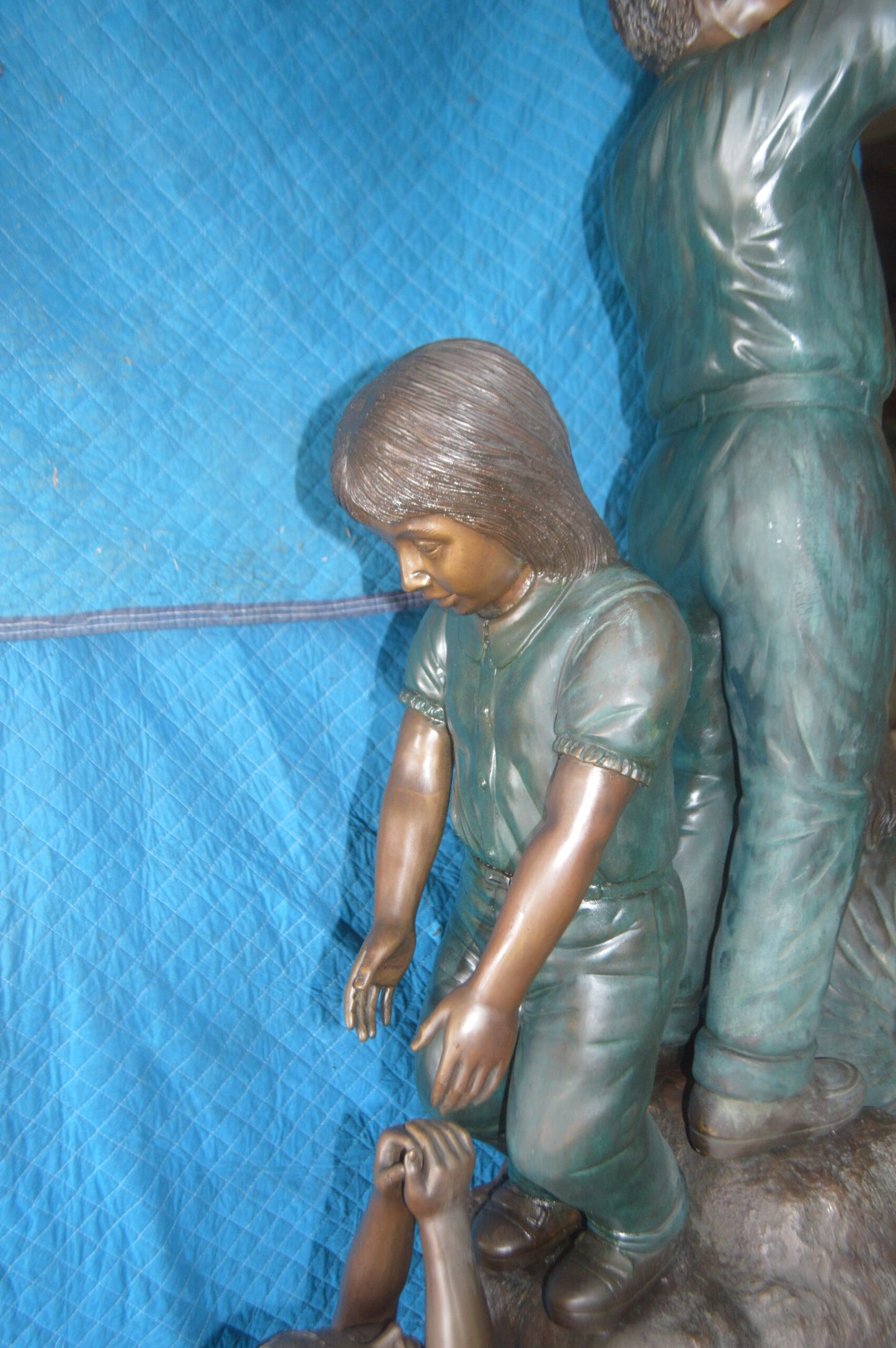 Four Kids Playing on a Rock Bronze Statue - Size: 49"L x 26"W x 89"H.
