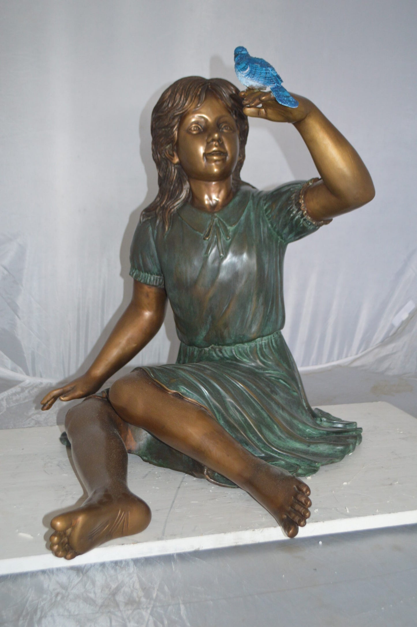 Girl with a Blue Sparrow Bronze Statue - Size: 26"L x 31"W x 25"H.