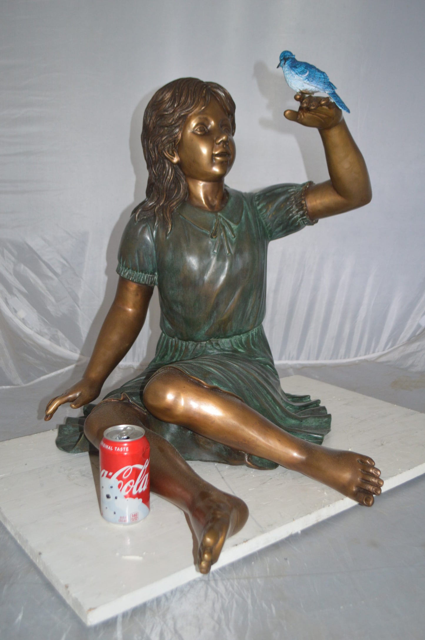 Girl with a Blue Sparrow Bronze Statue - Size: 26"L x 31"W x 25"H.