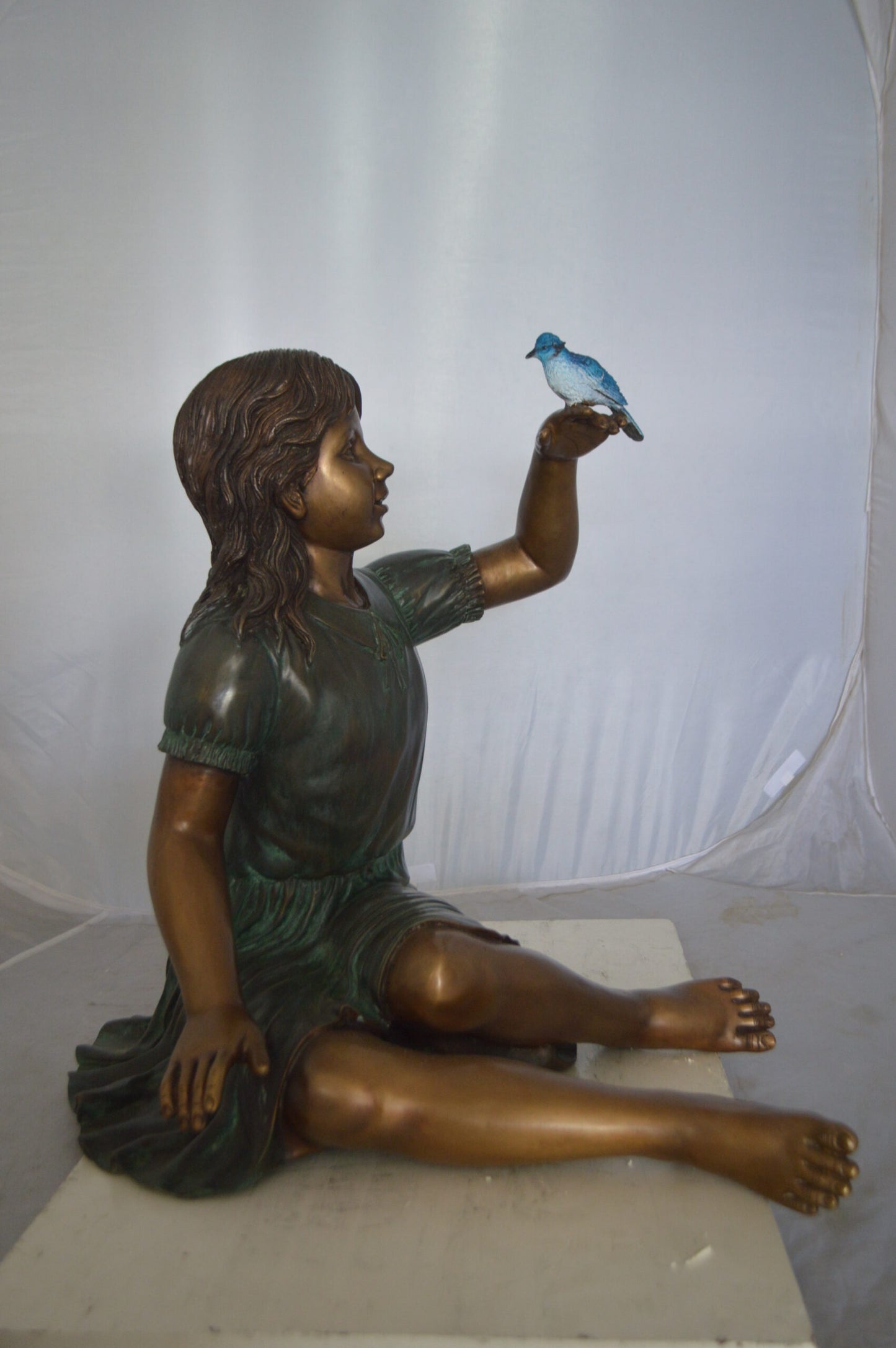 Girl with a Blue Sparrow Bronze Statue - Size: 26"L x 31"W x 25"H.