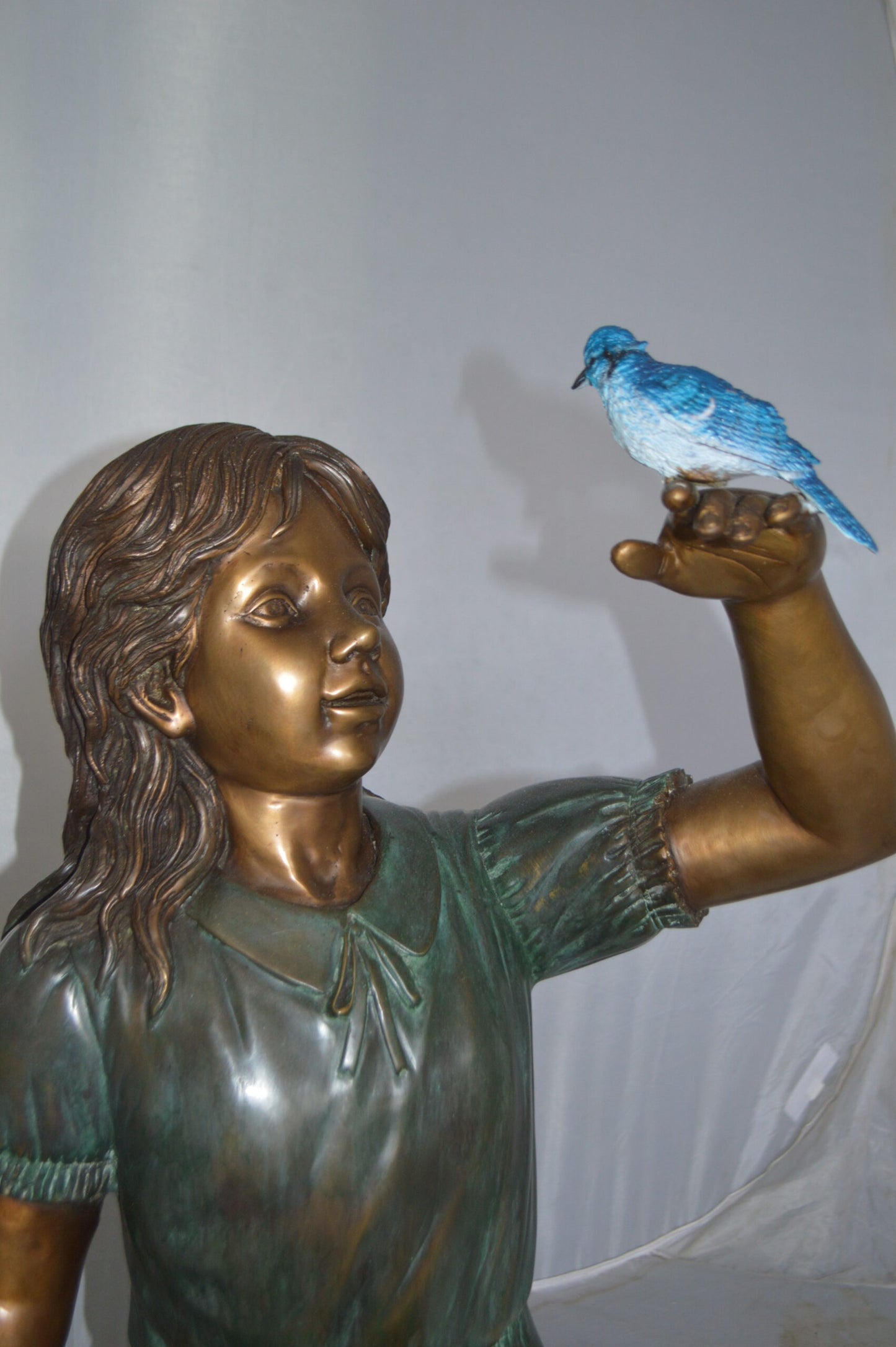 Girl with a Blue Sparrow Bronze Statue - Size: 26"L x 31"W x 25"H.