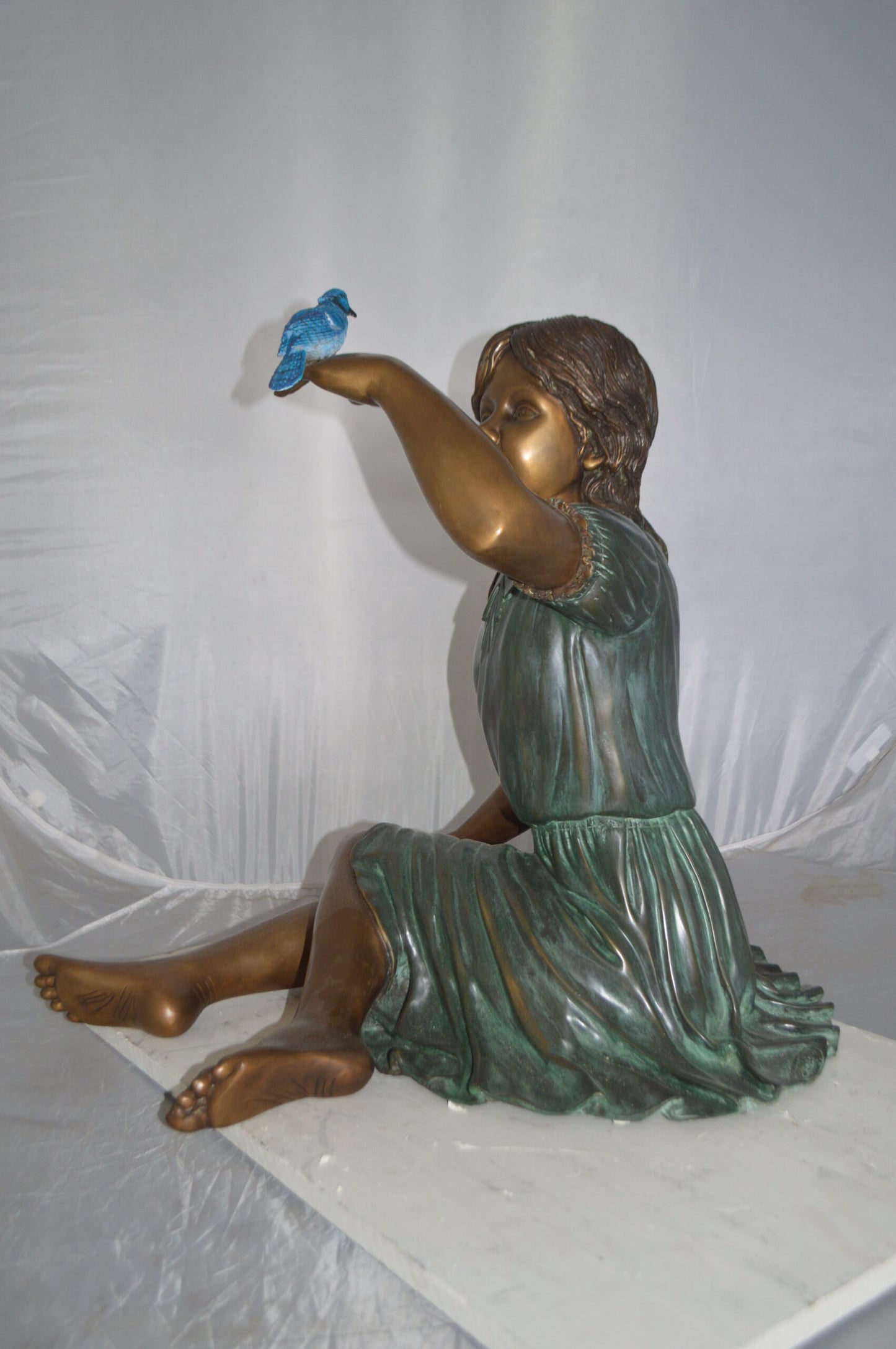 Girl with a Blue Sparrow Bronze Statue - Size: 26"L x 31"W x 25"H.