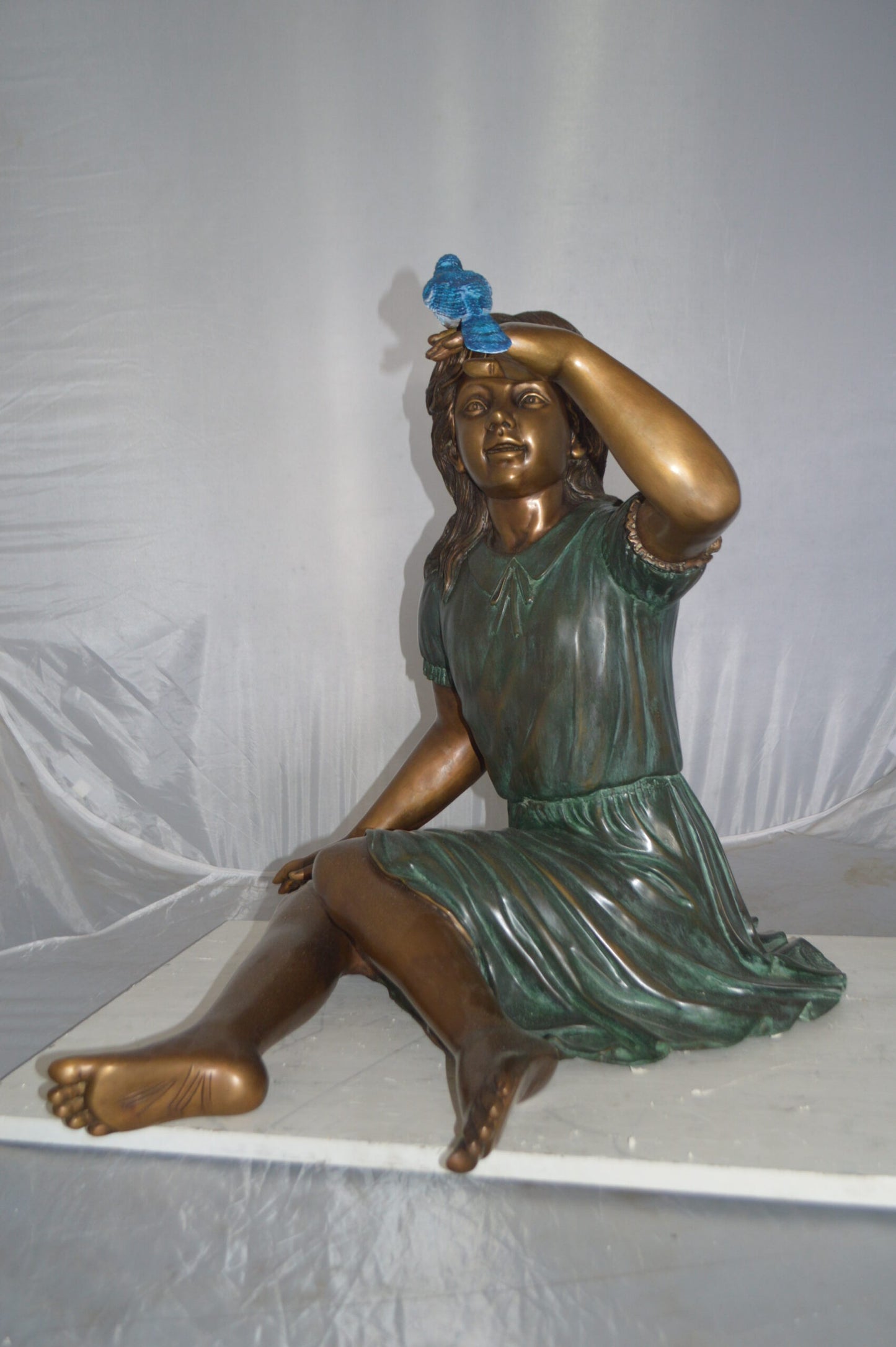 Girl with a Blue Sparrow Bronze Statue - Size: 26"L x 31"W x 25"H.