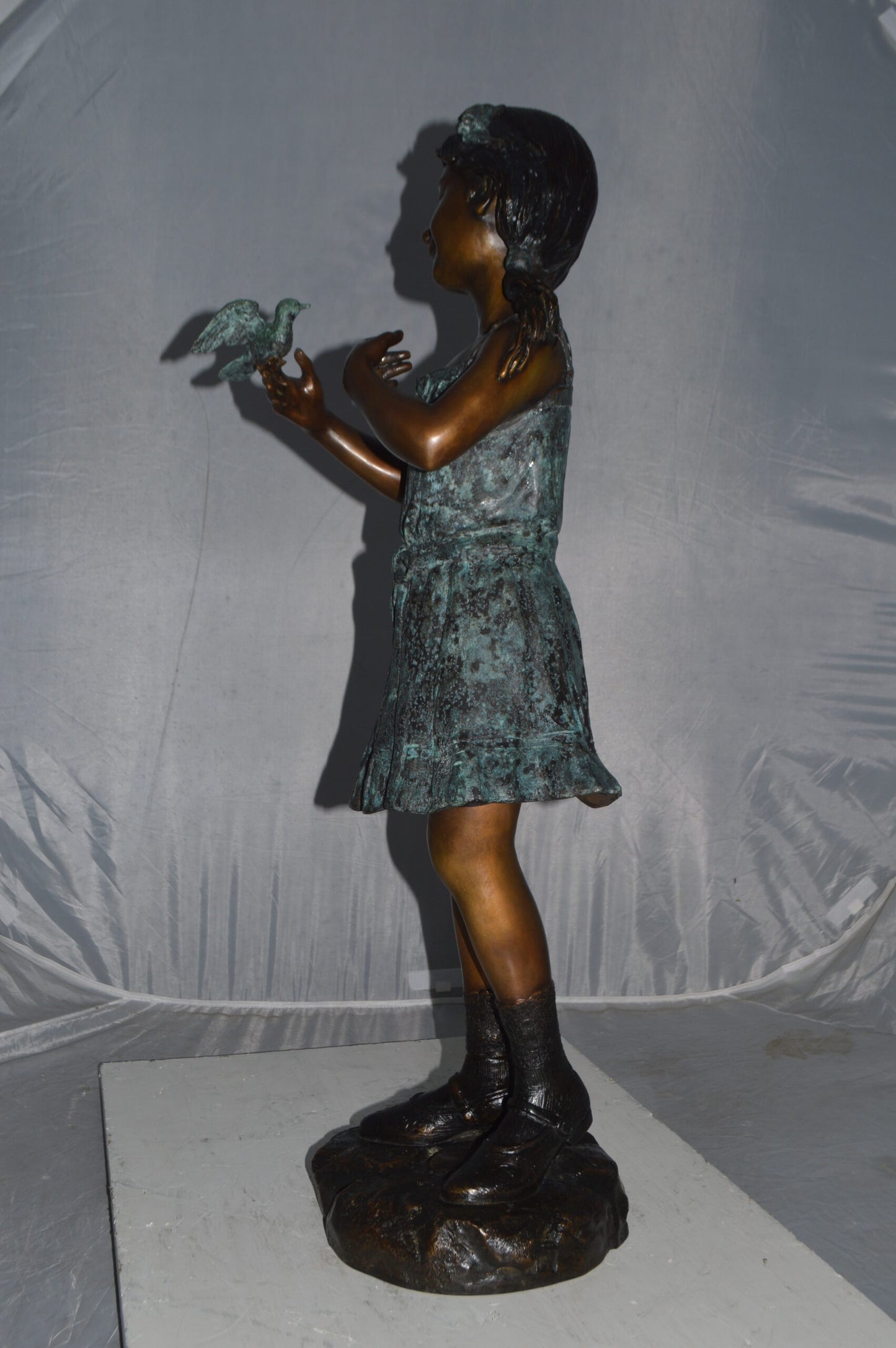 Girl Holding a Bird Bronze Statue - Size: 12"L x 12"W x 34"H.