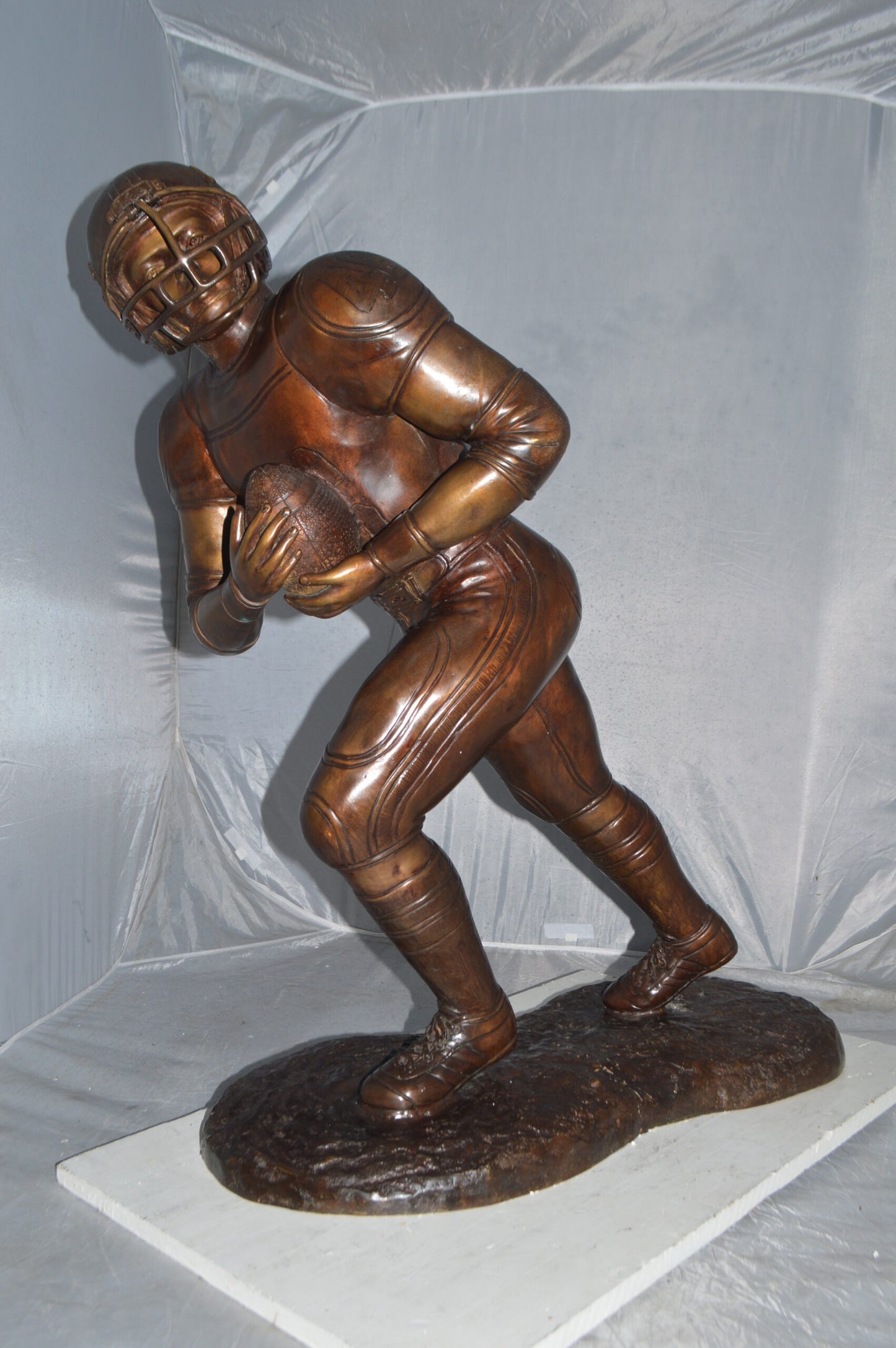 Football player Bronze Statue -  Size: 30"L x 12"W x 36"H.