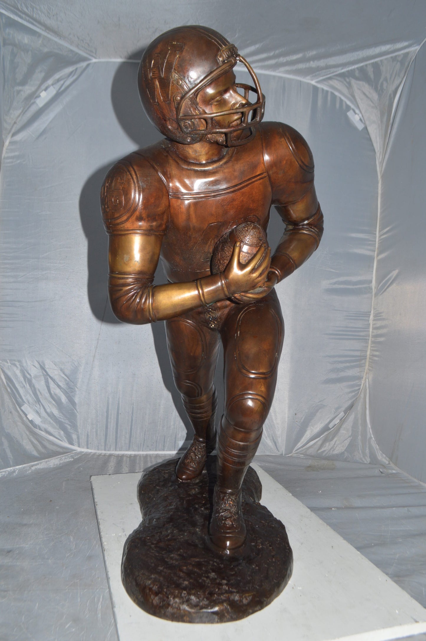 Football player Bronze Statue -  Size: 30"L x 12"W x 36"H.