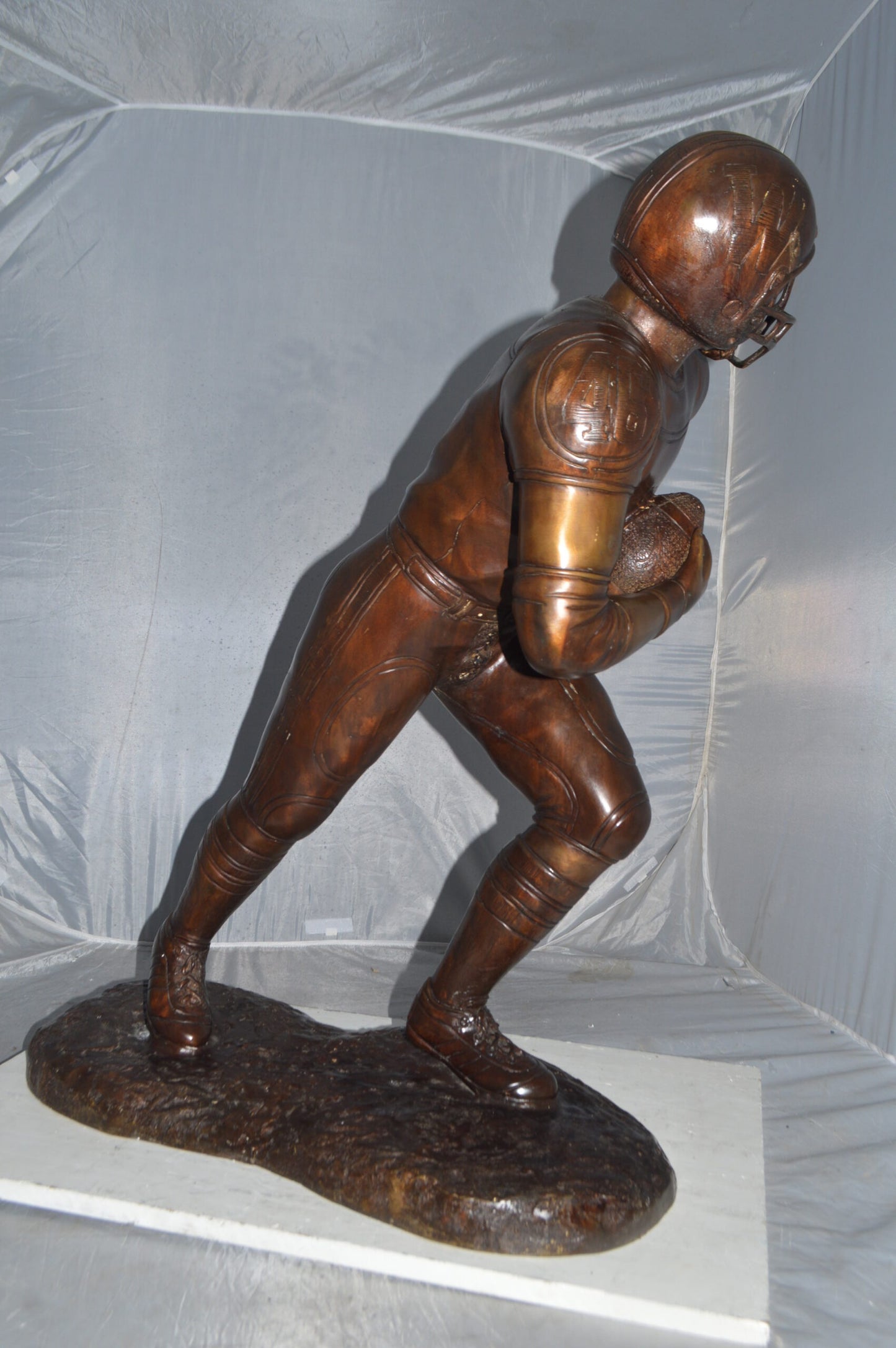 Football player Bronze Statue -  Size: 30"L x 12"W x 36"H.
