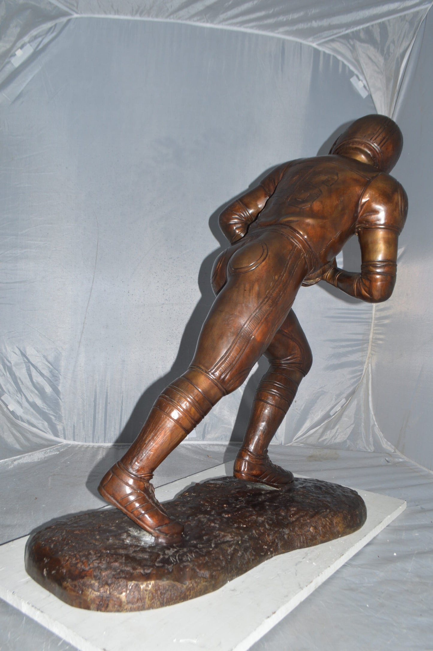 Football player Bronze Statue -  Size: 30"L x 12"W x 36"H.