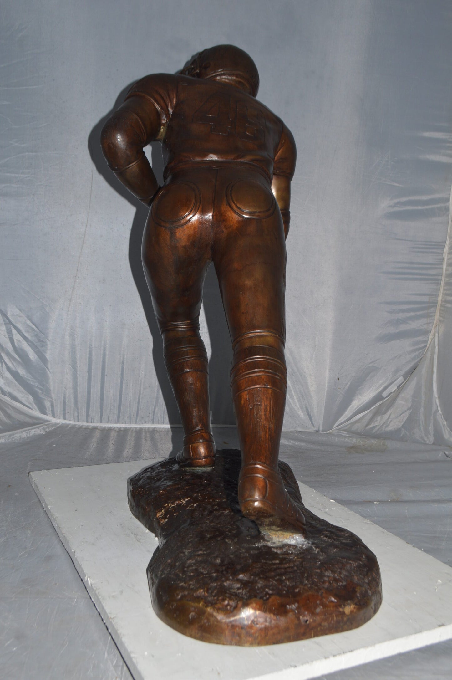 Football player Bronze Statue -  Size: 30"L x 12"W x 36"H.