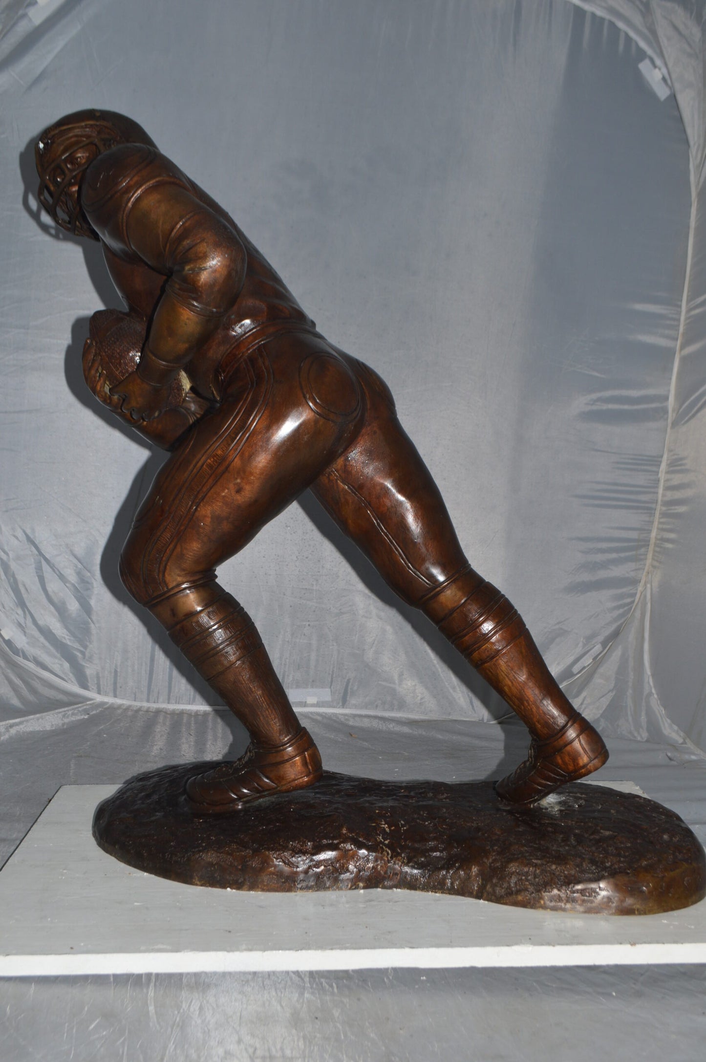Football player Bronze Statue -  Size: 30"L x 12"W x 36"H.