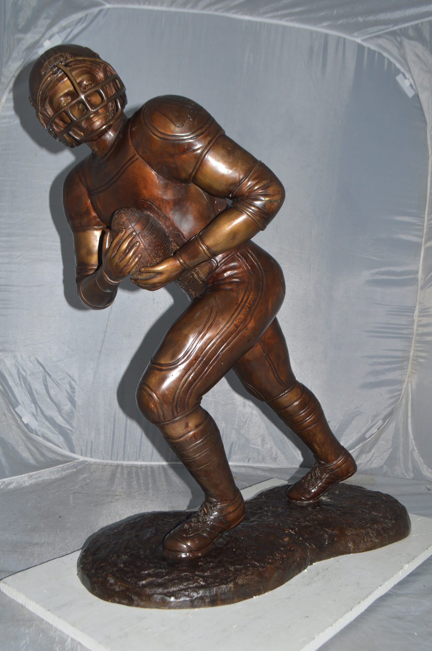 Football player Bronze Statue -  Size: 30"L x 12"W x 36"H.