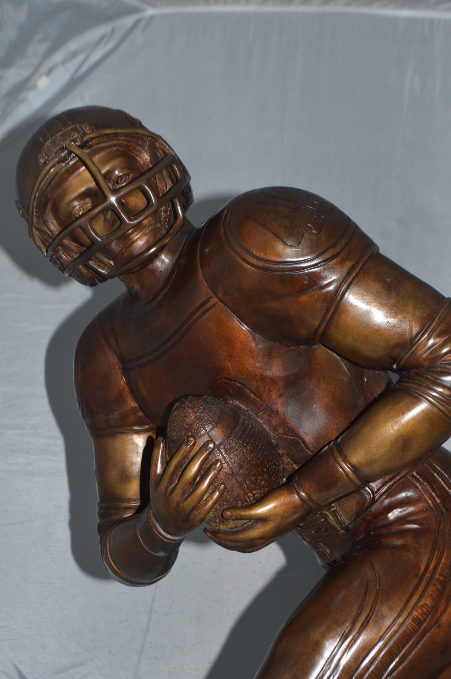 Football player Bronze Statue -  Size: 30"L x 12"W x 36"H.