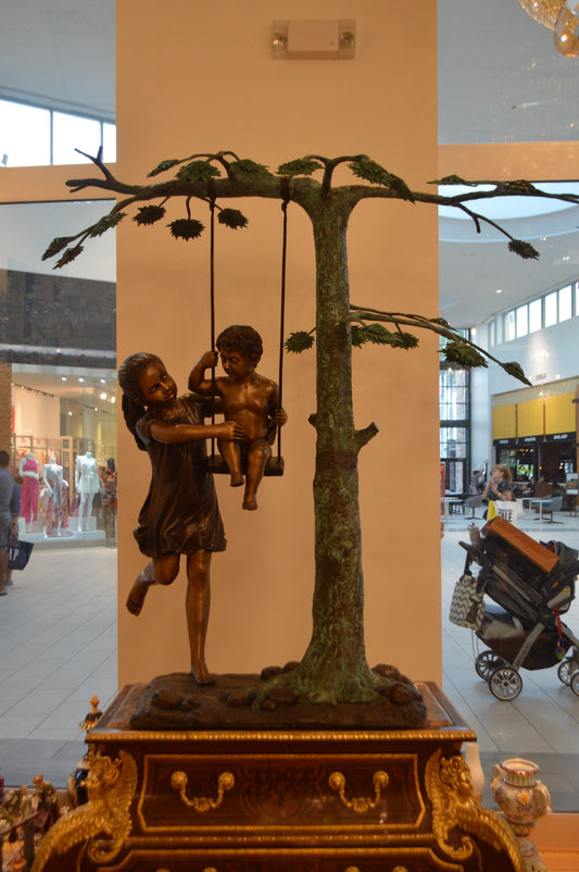 Swing Set Under A Three Bronze Statue - Size: 60"L x 33"W x 60"H.