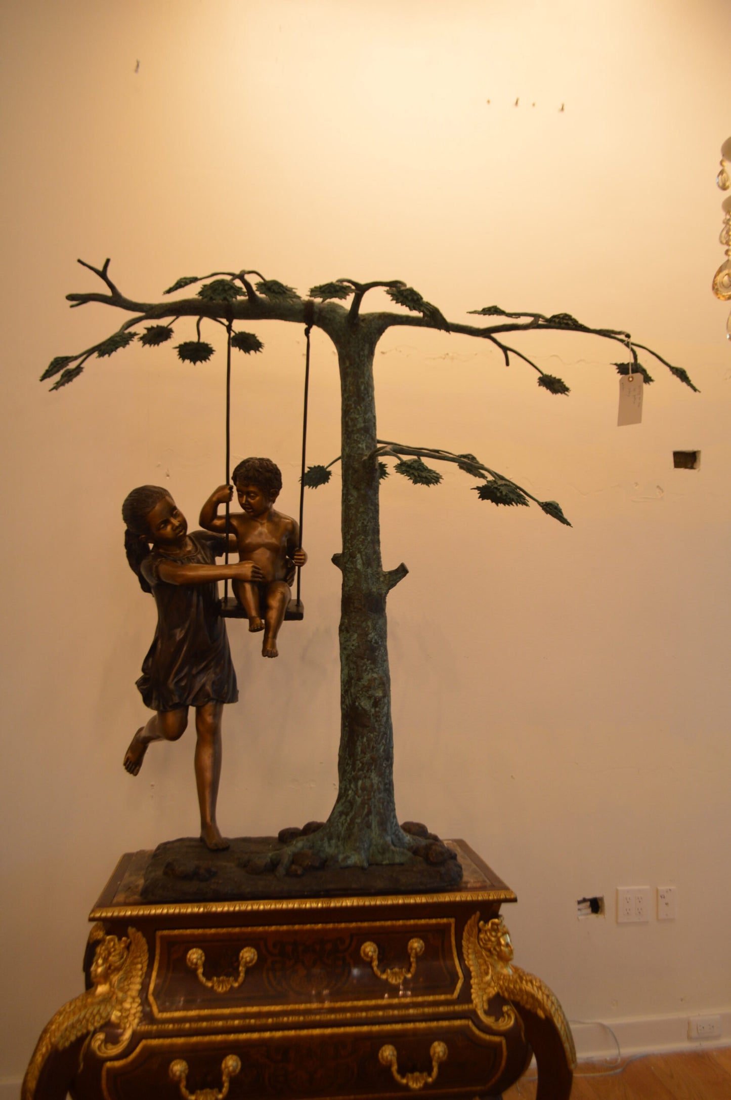 Swing Set Under A Three Bronze Statue - Size: 60"L x 33"W x 60"H.