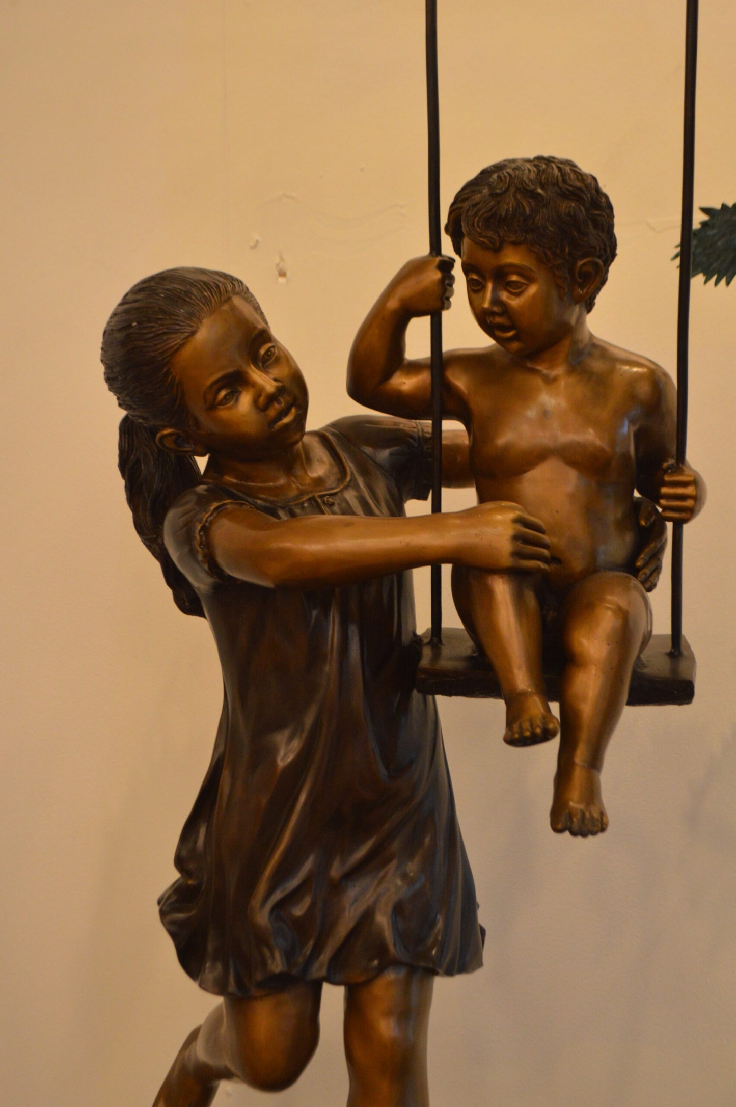 Swing Set Under A Three Bronze Statue - Size: 60"L x 33"W x 60"H.