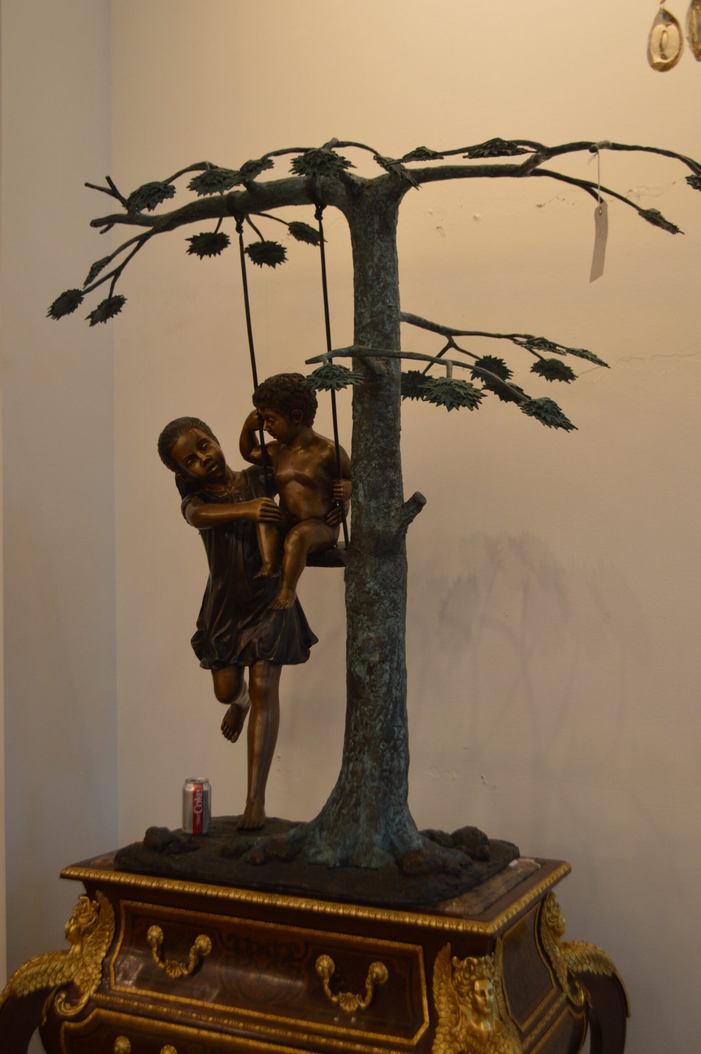 Swing Set Under A Three Bronze Statue - Size: 60"L x 33"W x 60"H.