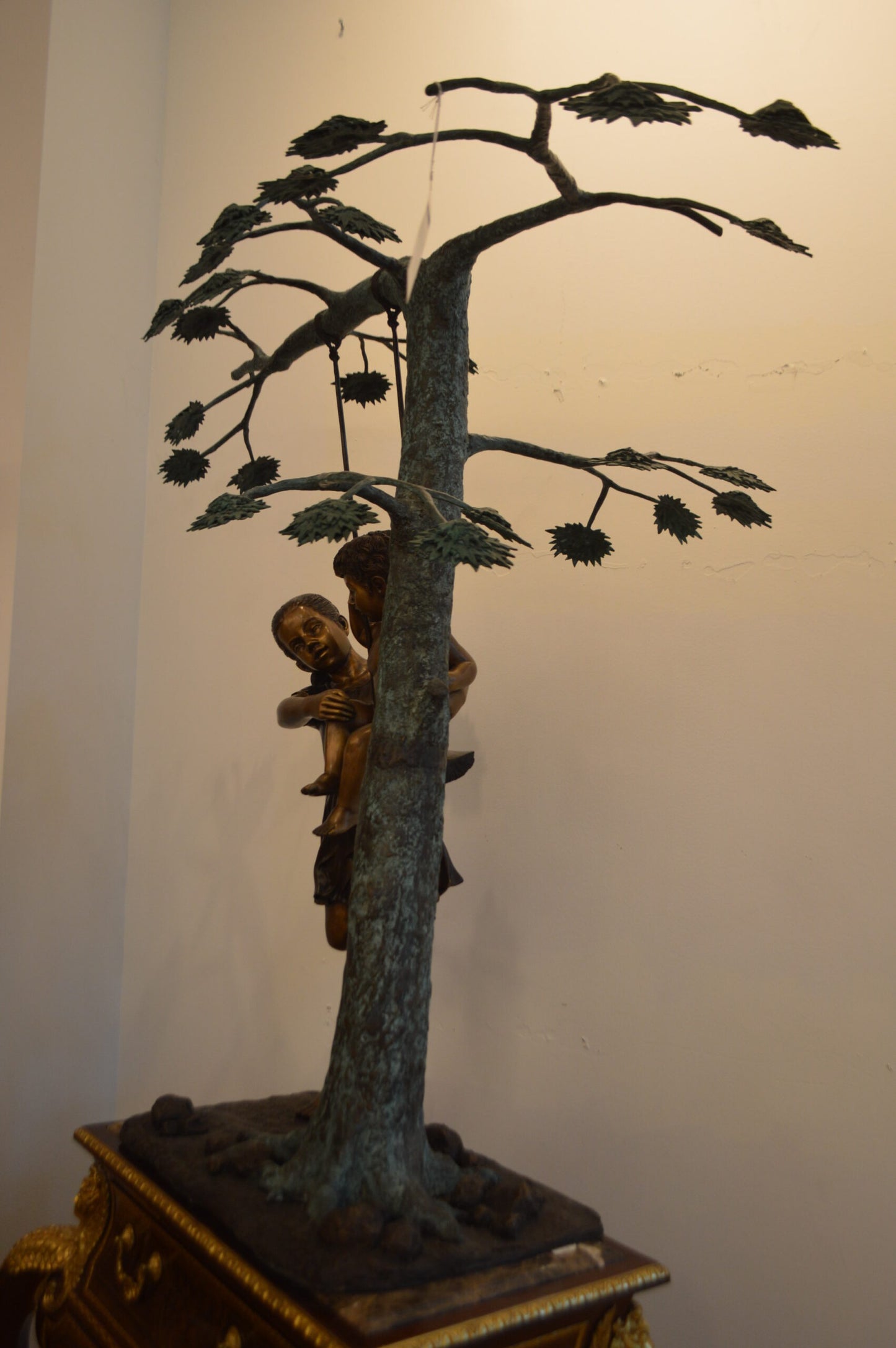 Swing Set Under A Three Bronze Statue - Size: 60"L x 33"W x 60"H.