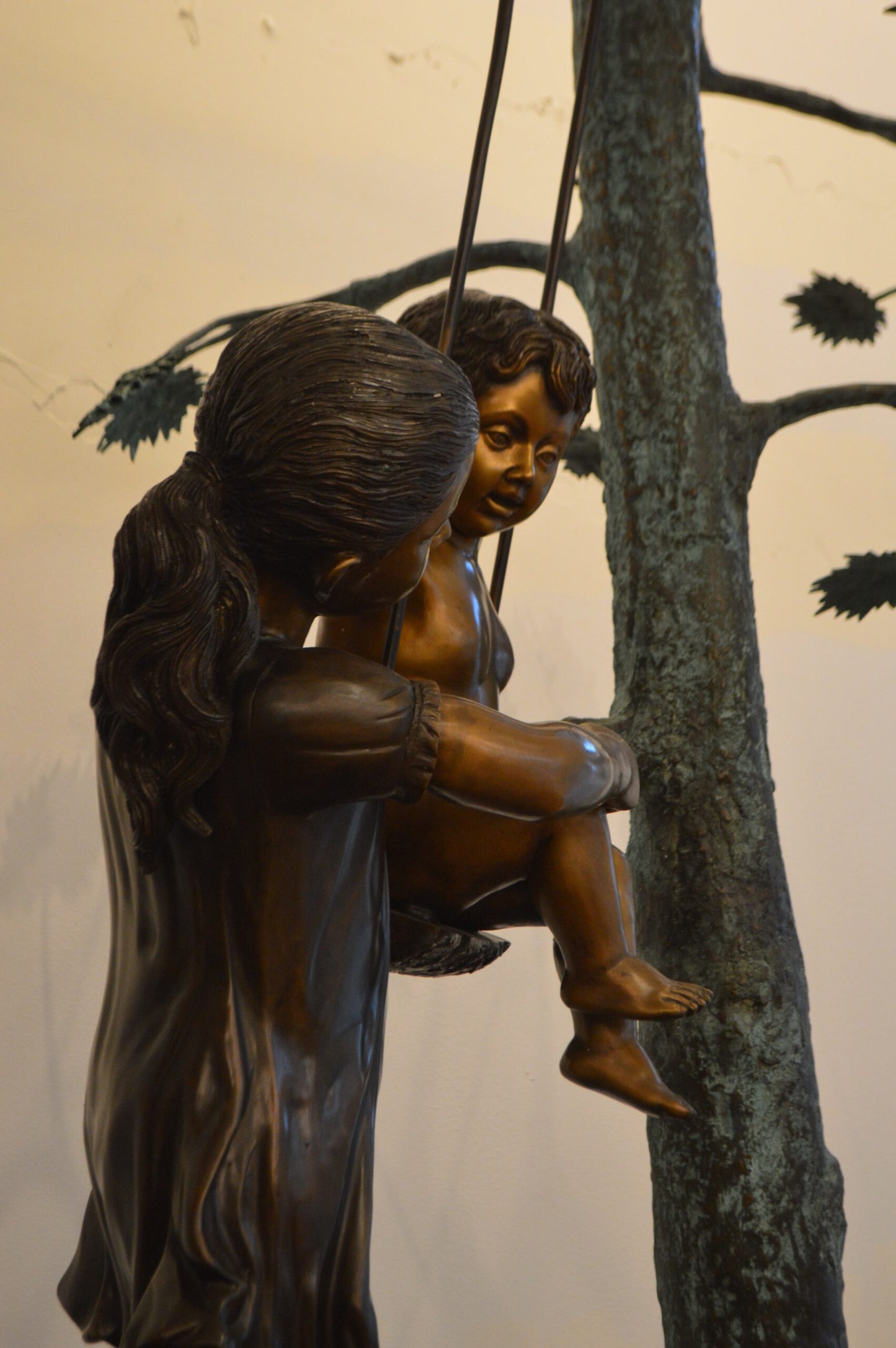 Swing Set Under A Three Bronze Statue - Size: 60"L x 33"W x 60"H.