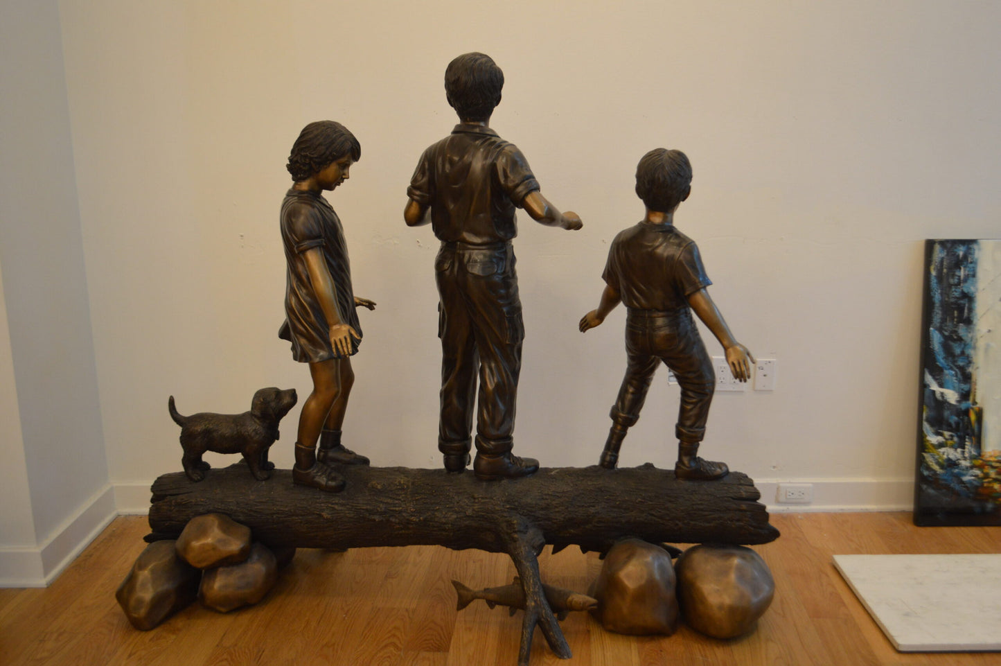 Three Kids With A Dog On A Log Bronze Statue - Size: 78"L x 26"W x 62"H.