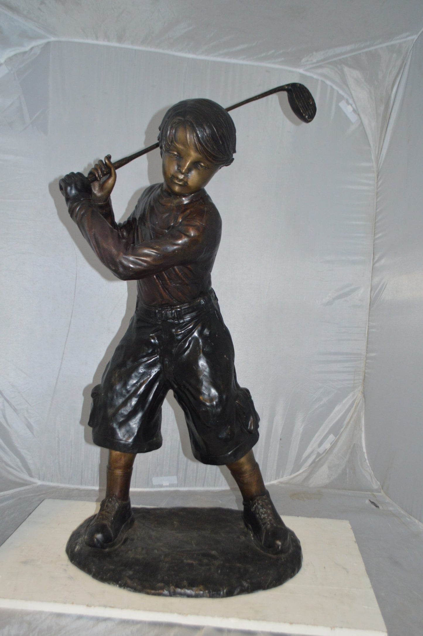 Young Boy Plays Golf Bronze Statue -  Size: 19"L x 21"W x 45"H.