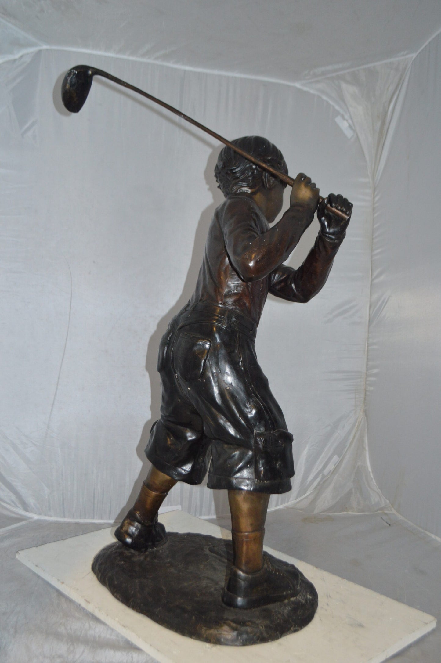 Young Boy Plays Golf Bronze Statue - Size: 19"L x 21"W x 45"H.
