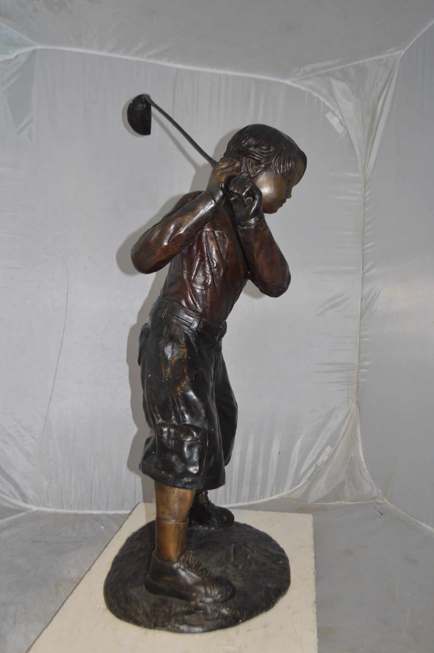 Young Boy Plays Golf Bronze Statue -  Size: 19"L x 21"W x 45"H.