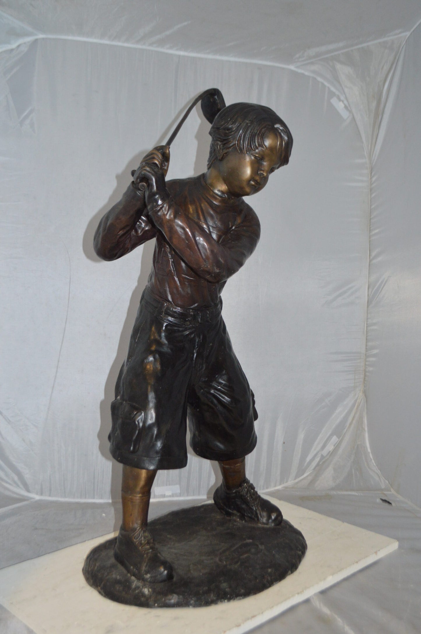 Young Boy Plays Golf Bronze Statue -  Size: 19"L x 21"W x 45"H.