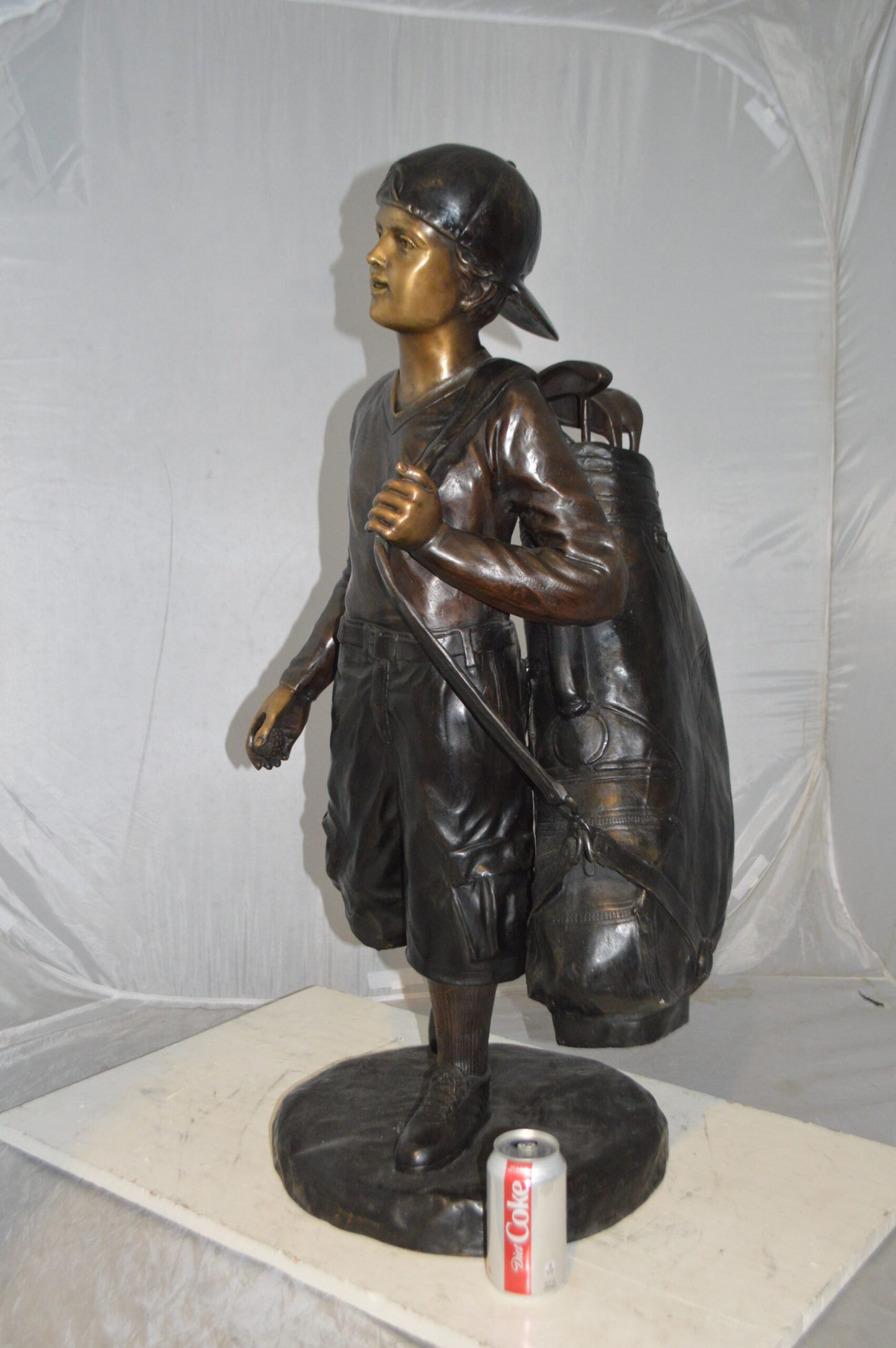 Boy Carrying A Golf Bag Bronze Statue - Size: 15"L x 15"W x 38"H.