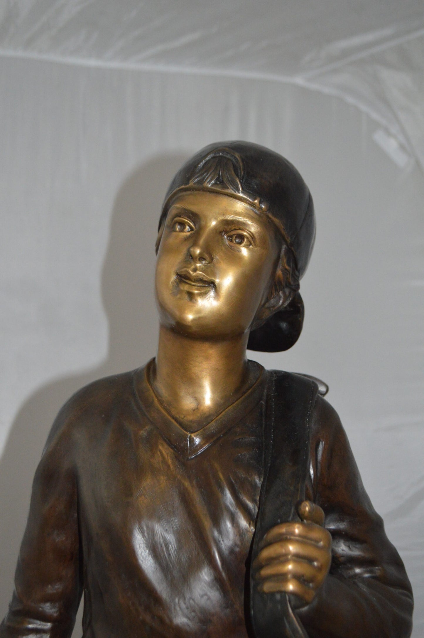 Boy Carrying A Golf Bag Bronze Statue - Size: 15"L x 15"W x 38"H.