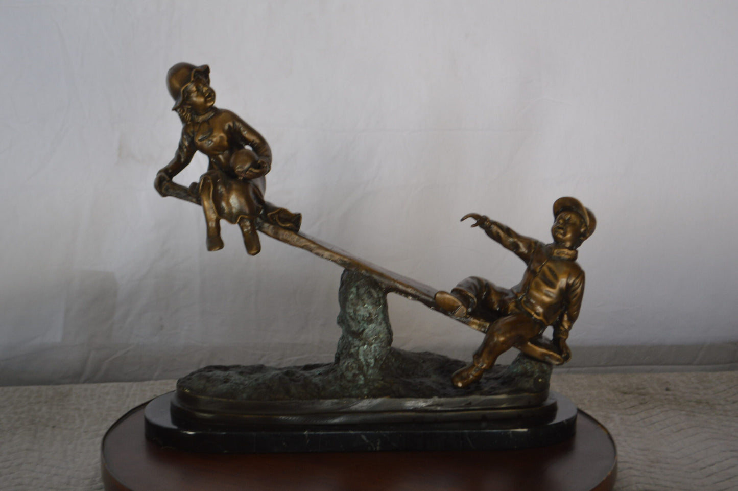 Boys Playing Seesaw on a Marble Base Bronze Statue - Size: 22"L x 8"W x 17"H.