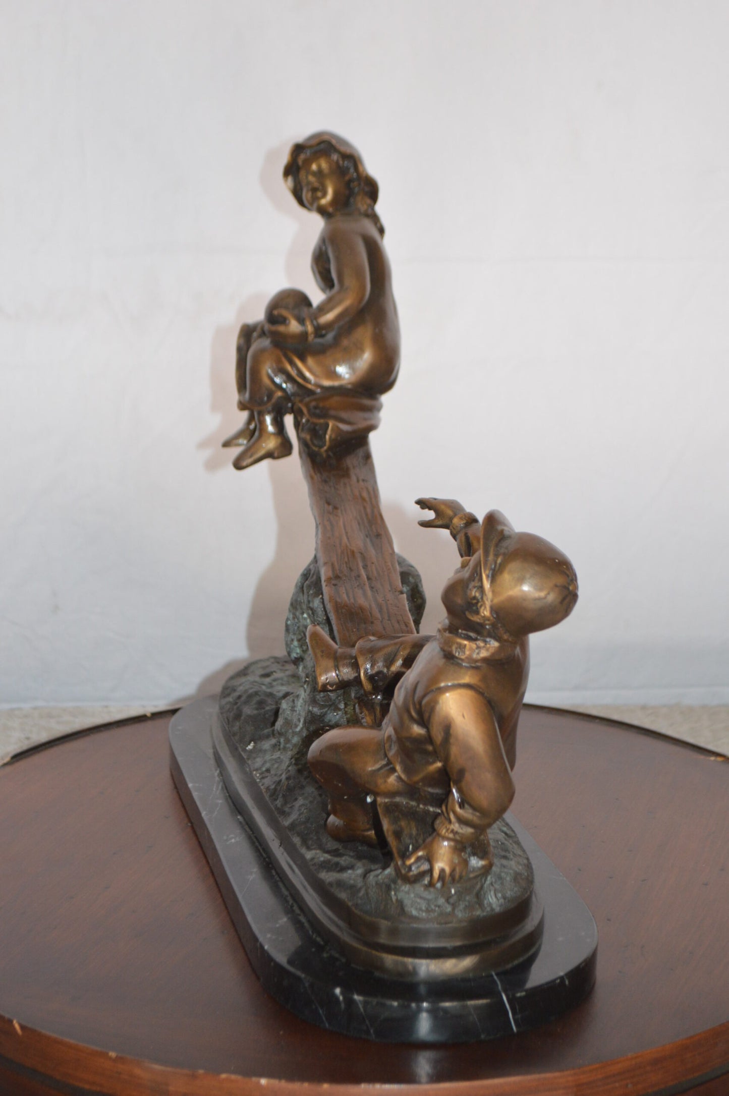 Boys Playing Seesaw on a Marble Base Bronze Statue - Size: 22"L x 8"W x 17"H.