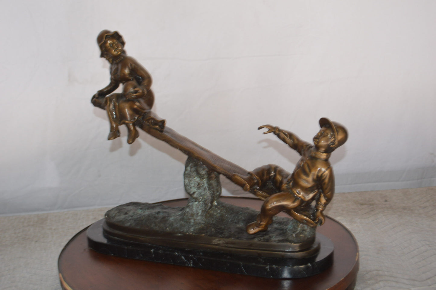 Boys Playing Seesaw on a Marble Base Bronze Statue - Size: 22"L x 8"W x 17"H.