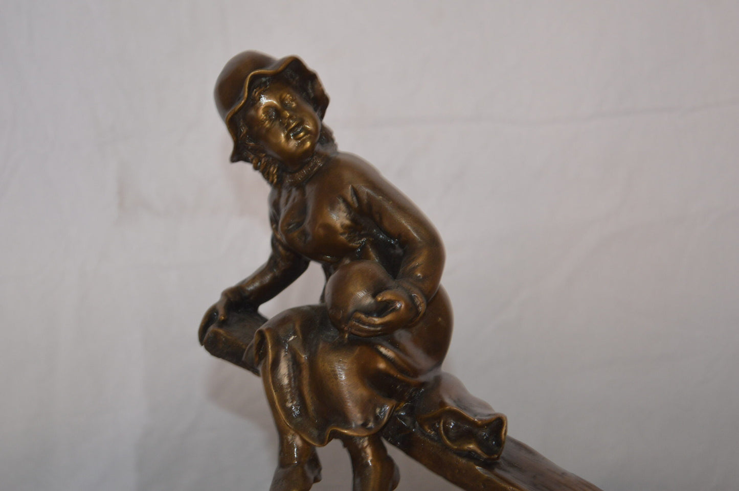 Boys Playing Seesaw on a Marble Base Bronze Statue - Size: 22"L x 8"W x 17"H.