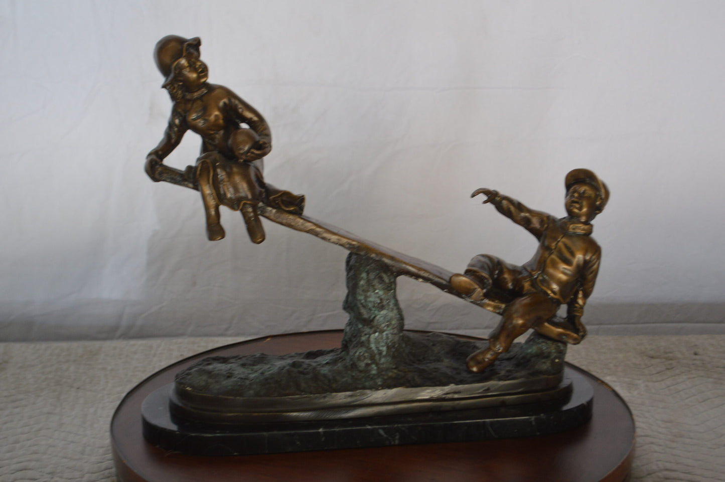 Boys Playing Seesaw on a Marble Base Bronze Statue - Size: 22"L x 8"W x 17"H.