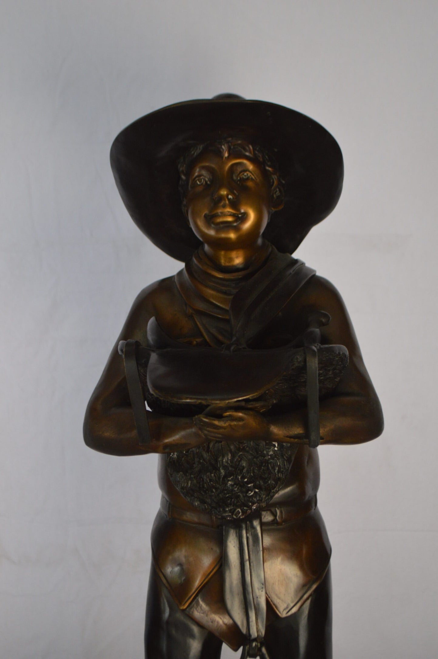 Cowboy Holding a Saddle Bronze Statue  -  Size: 12"L x 11"W x 32"H.