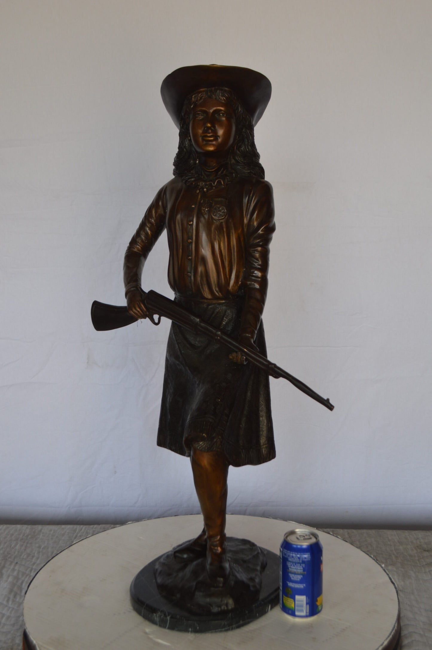 Annie Oakley Bronze Statue Mounted on a Marble Base -  Size: 11"L x 9"W x 33"H.