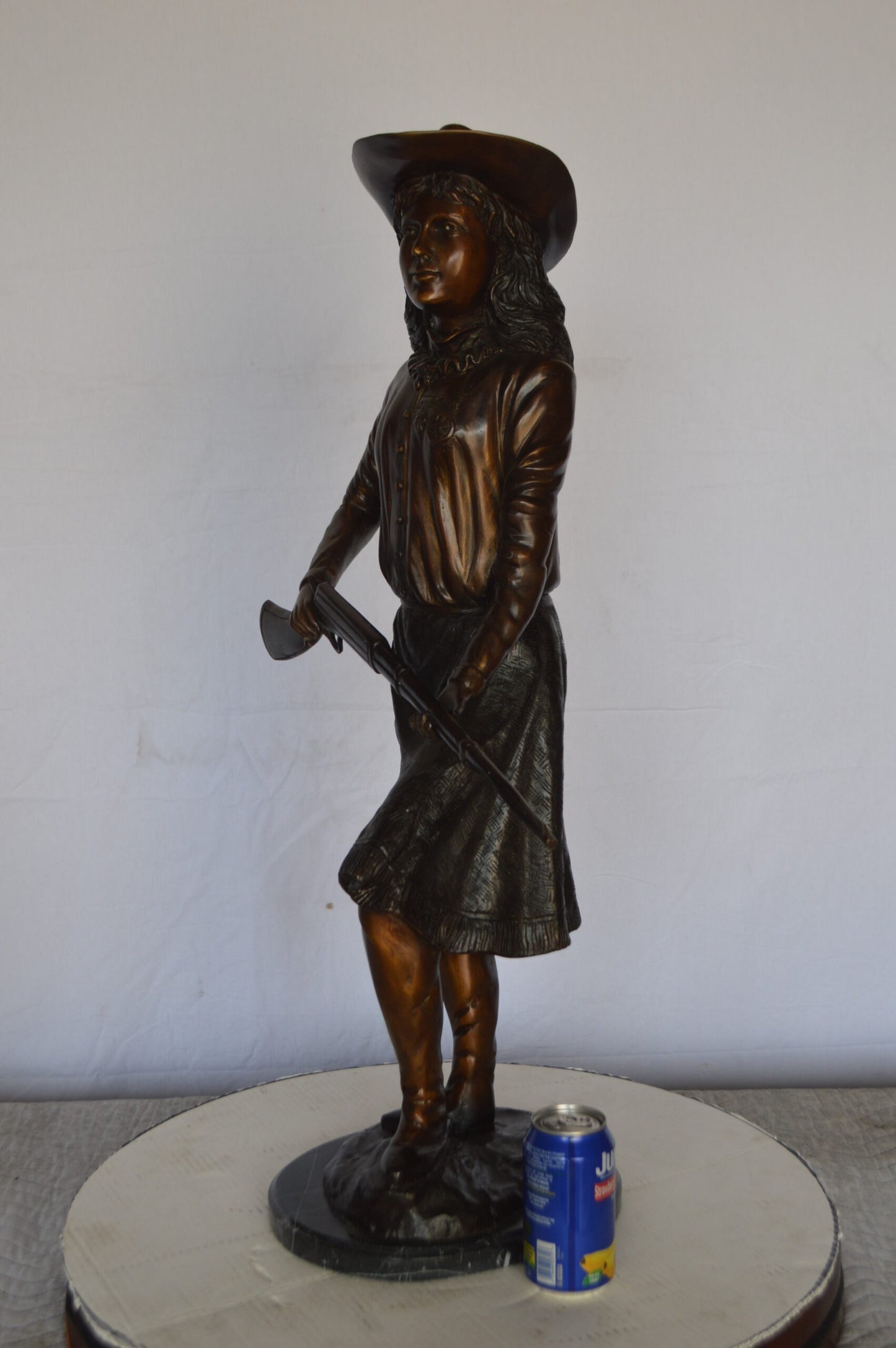 Annie Oakley Bronze Statue Mounted on a Marble Base -  Size: 11"L x 9"W x 33"H.