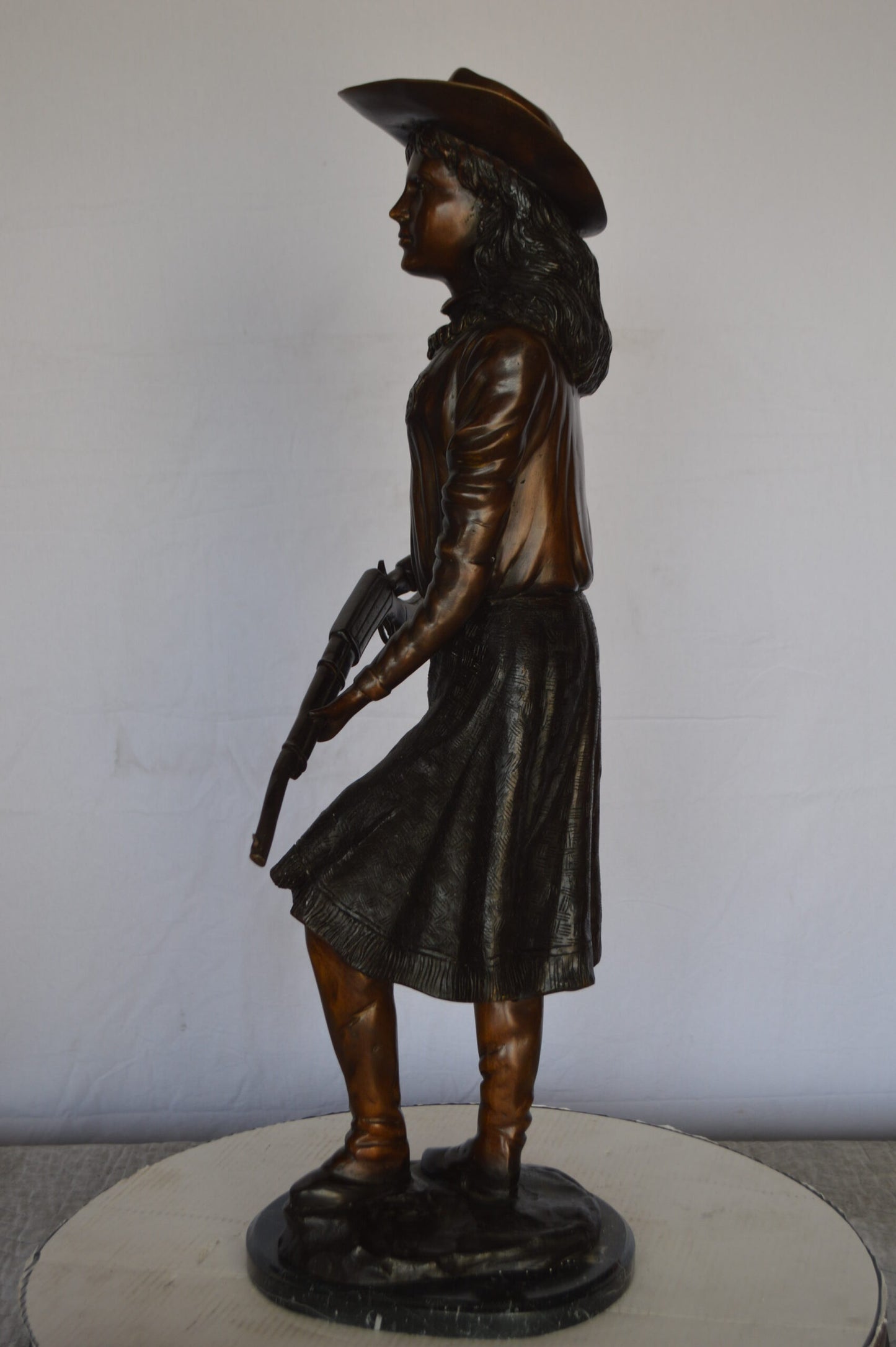 Annie Oakley Bronze Statue Mounted on a Marble Base -  Size: 11"L x 9"W x 33"H.