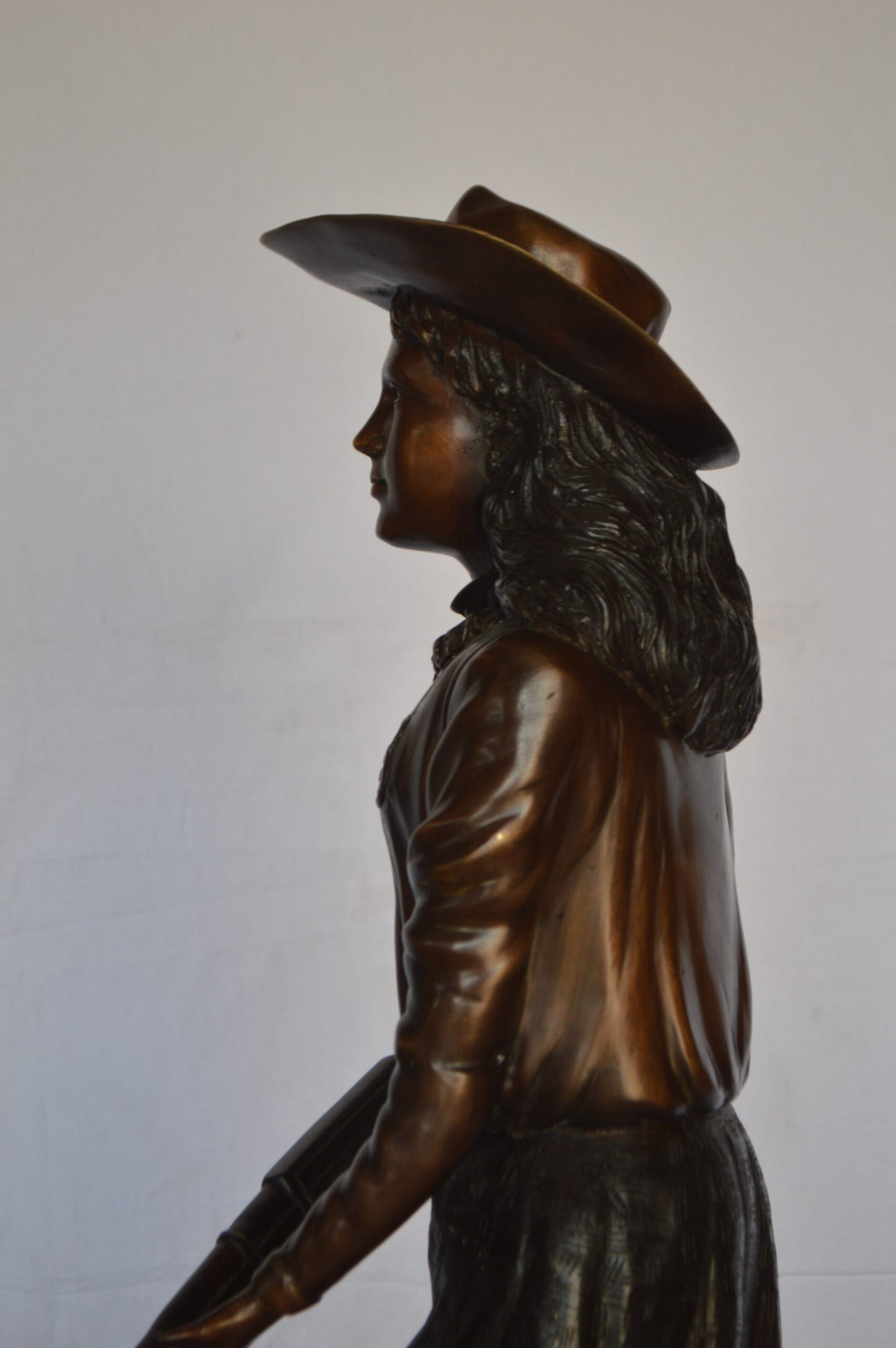 Annie Oakley Bronze Statue Mounted on a Marble Base -  Size: 11"L x 9"W x 33"H.