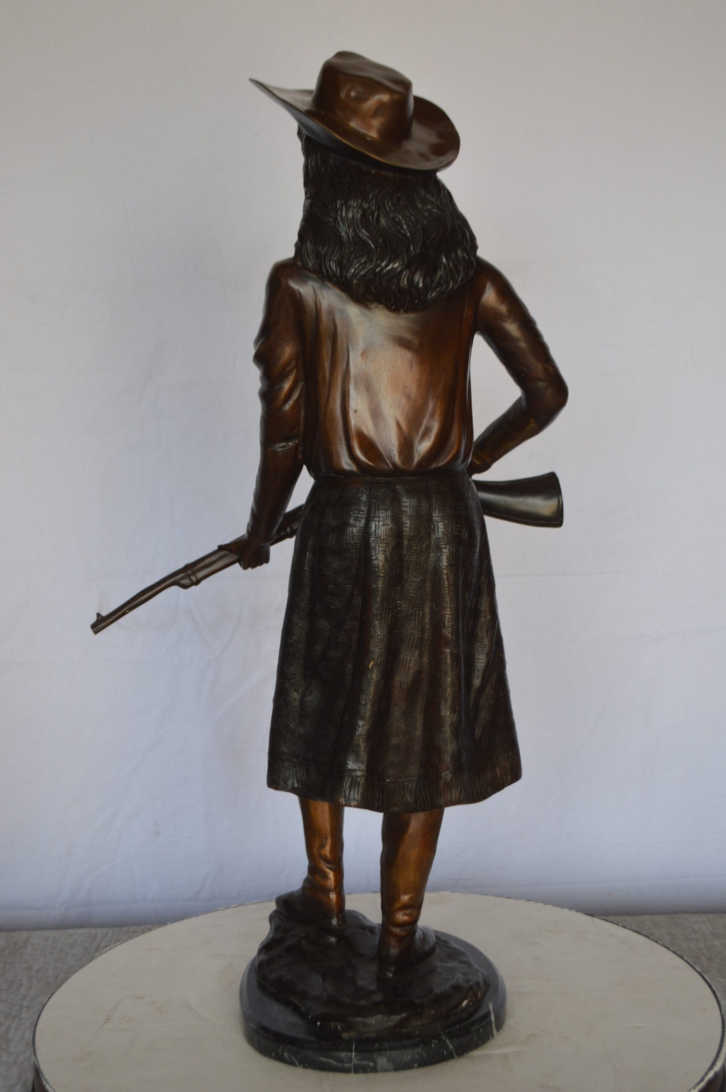 Annie Oakley Bronze Statue Mounted on a Marble Base -  Size: 11"L x 9"W x 33"H.