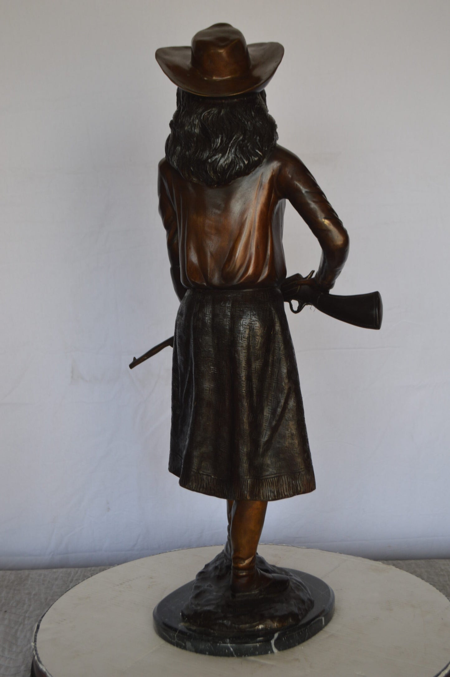 Annie Oakley Bronze Statue Mounted on a Marble Base -  Size: 11"L x 9"W x 33"H.