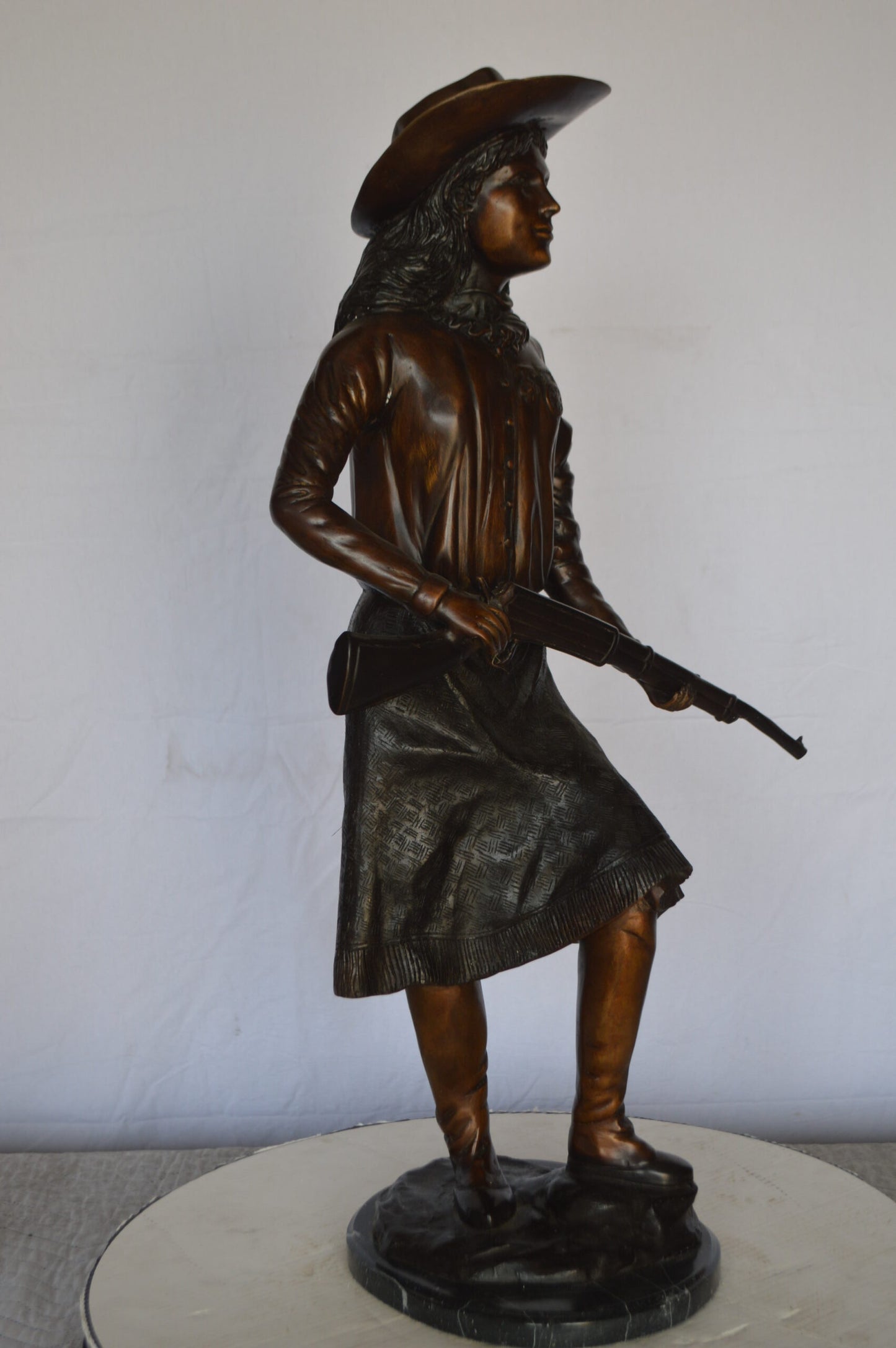 Annie Oakley Bronze Statue Mounted on a Marble Base -  Size: 11"L x 9"W x 33"H.