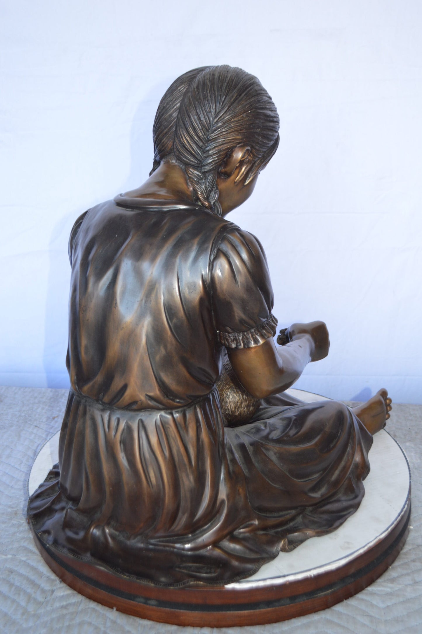 Sandra Sitting With Her Rabbit Bronze Statue - Size: 25"L x 18"W x 25"H.