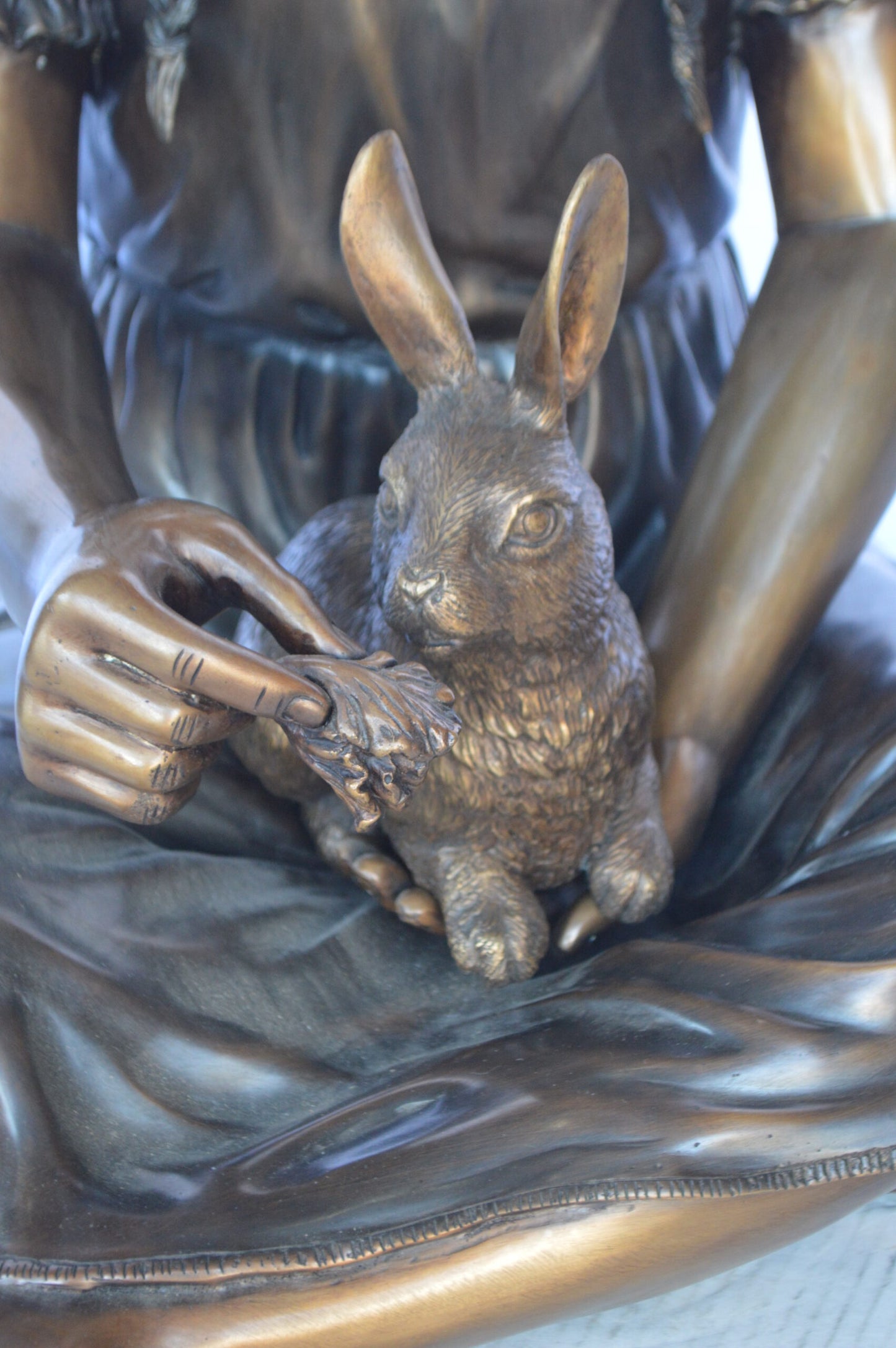 Sandra Sitting With Her Rabbit Bronze Statue - Size: 25"L x 18"W x 25"H.