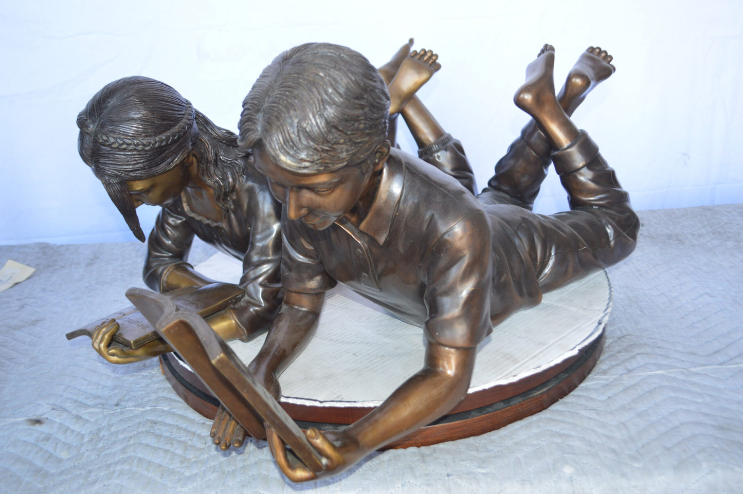 A Set of Boy and Girl Reading Books Bronze Statue - Size: 31"L x 10"W x 14"H.