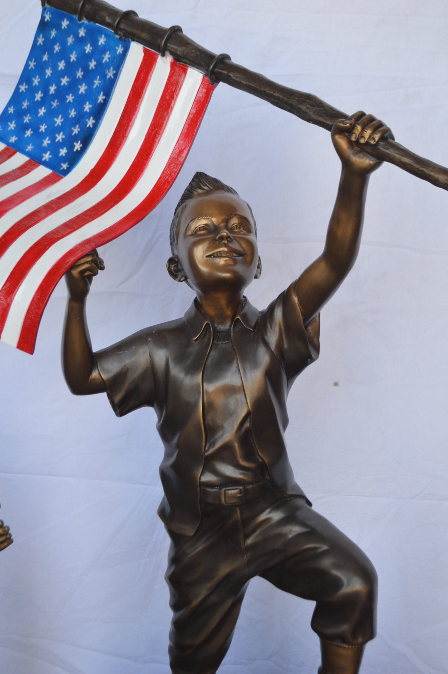 Two Kids on Rock W the American Flag Bronze Statue -  Size: 50"L x 22"W x 58"H.