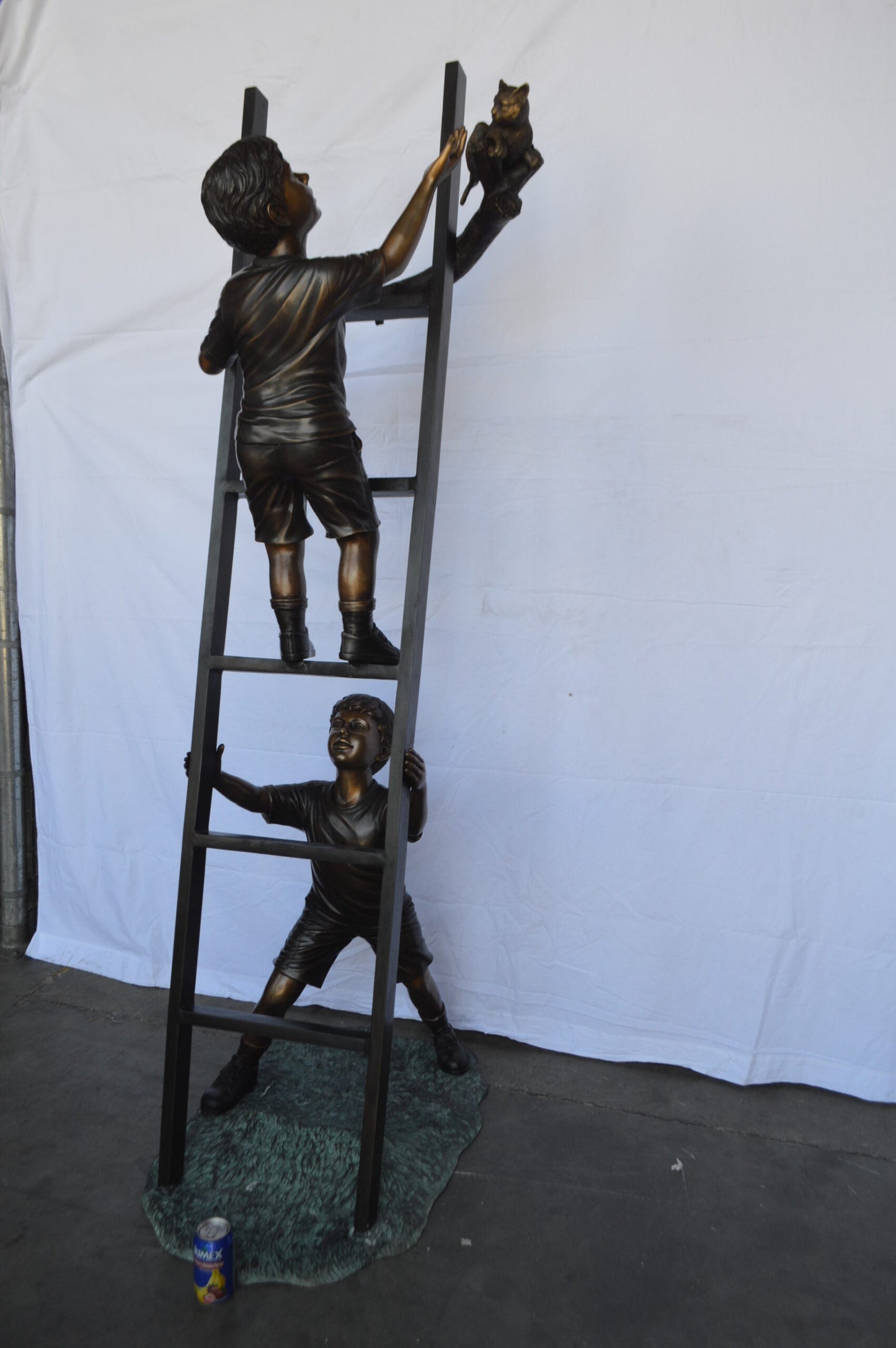 Two Kids Climb a Ladder Saving a Cat Bronze Statue - Size: 35"L x 24"W x 81"H.