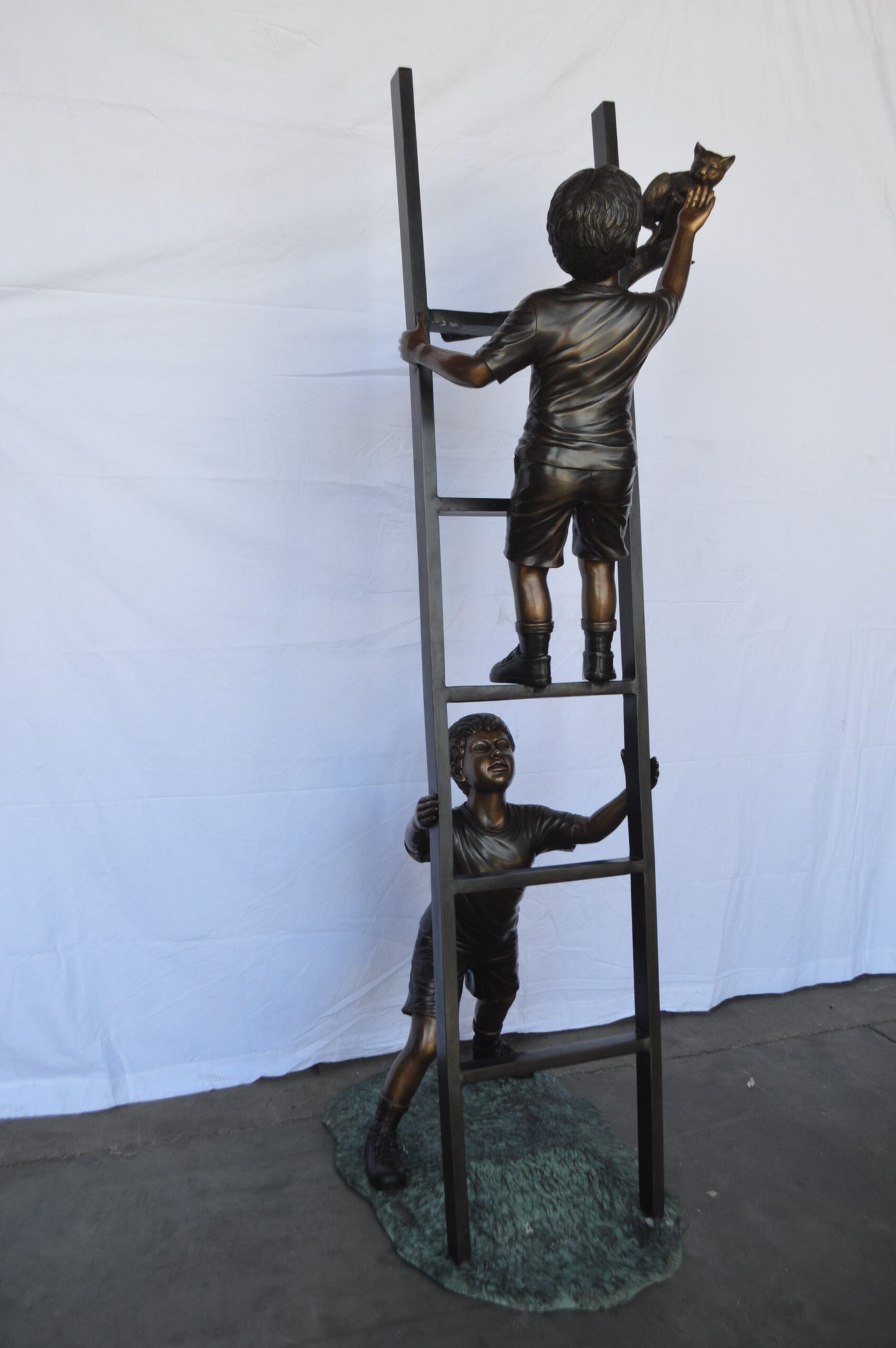 Two Kids Climb a Ladder Saving a Cat Bronze Statue - Size: 35"L x 24"W x 81"H.
