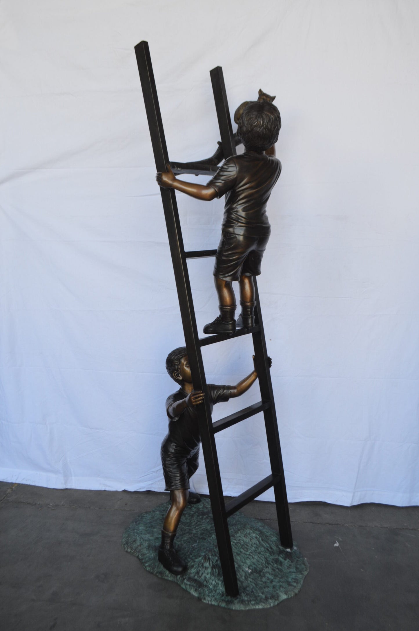 Two Kids Climb a Ladder Saving a Cat Bronze Statue - Size: 35"L x 24"W x 81"H.